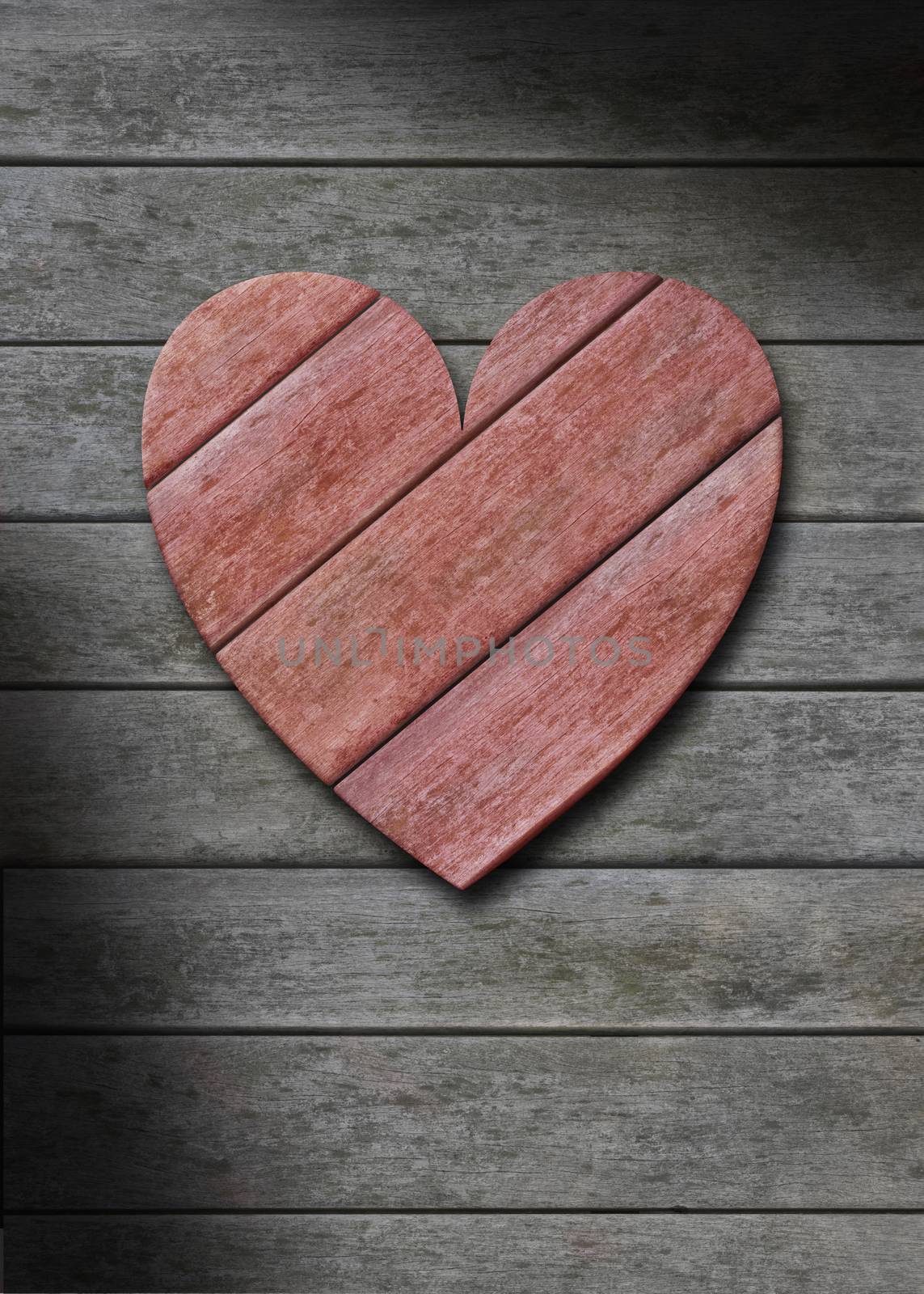 Red wood heart against a gray weathered wooden background