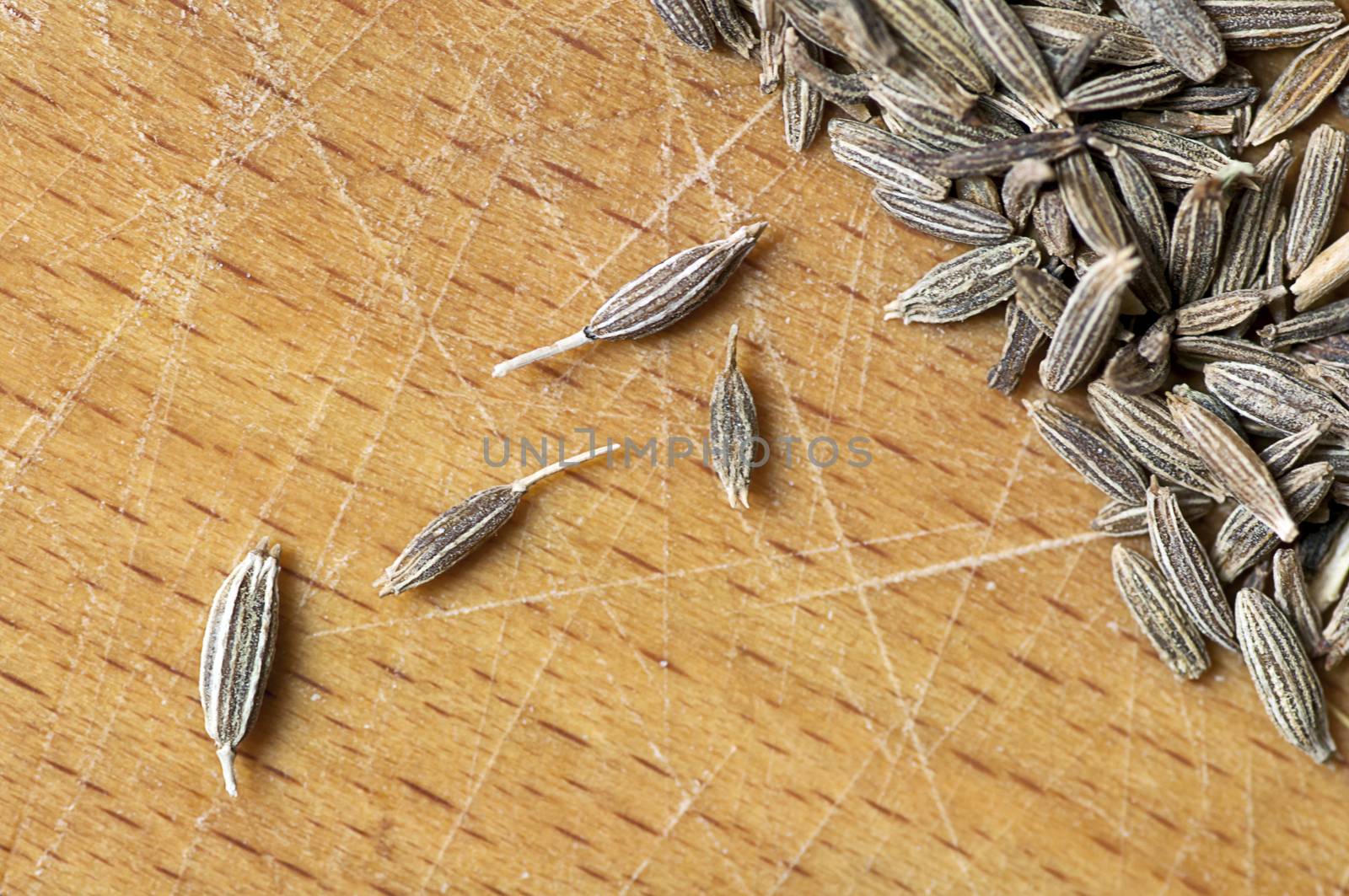 Cumin seeds close up on cutting board