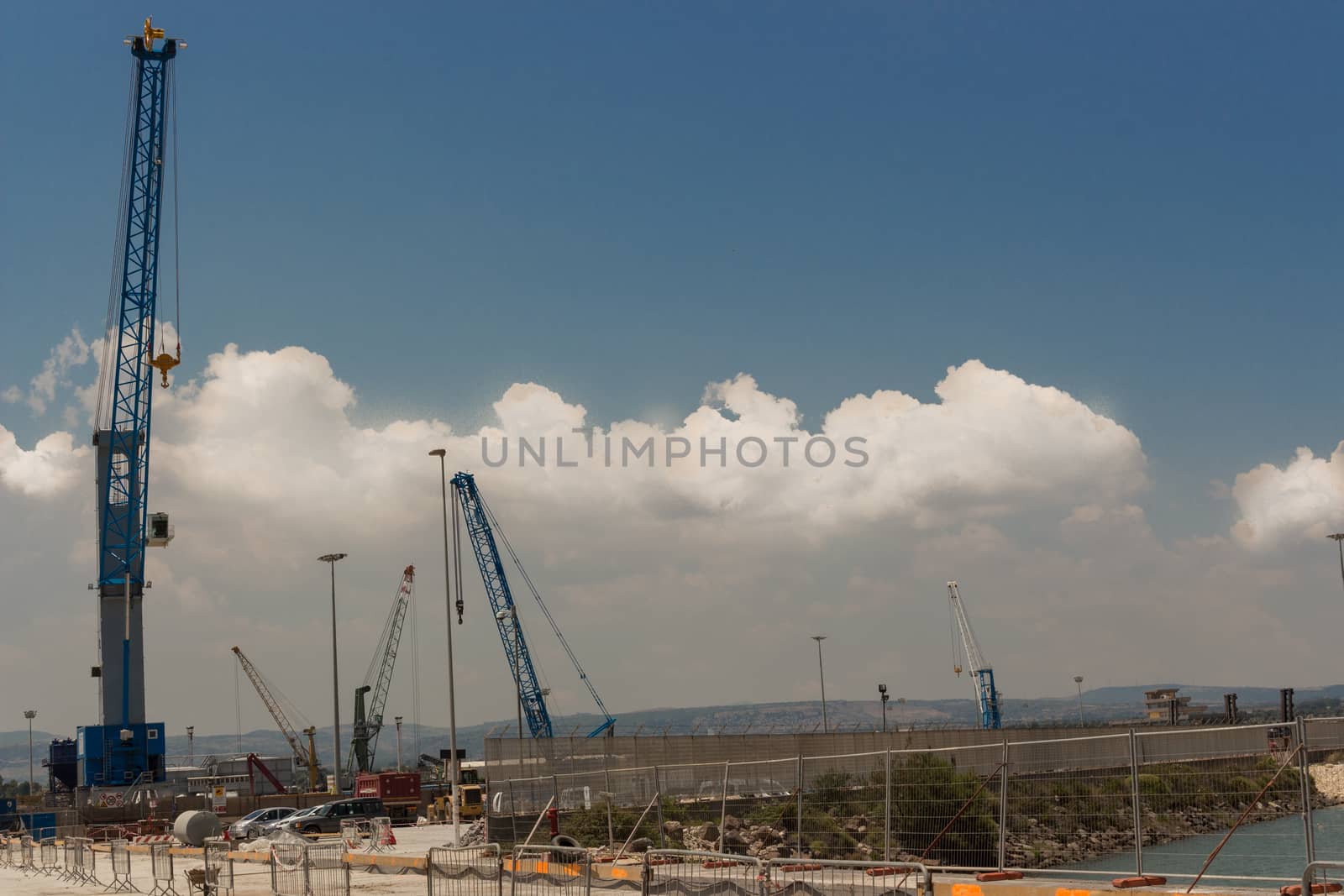 Silhouettes of construction cranes in the sky