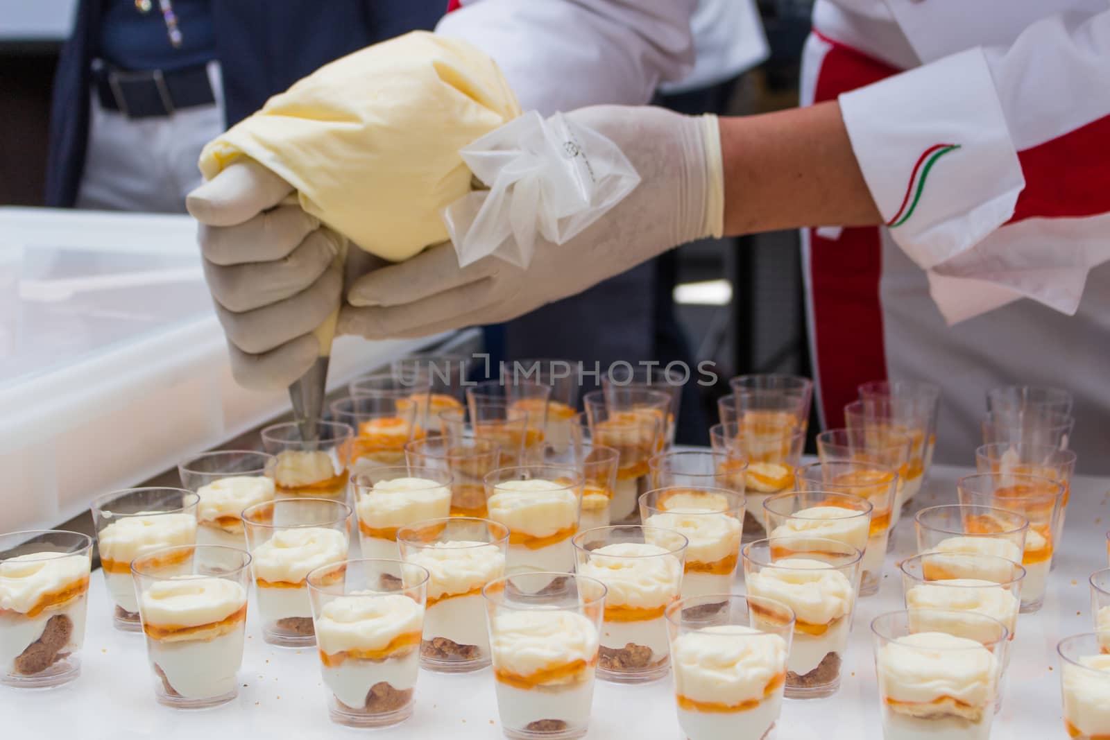 pastry chef is decorating a dessert