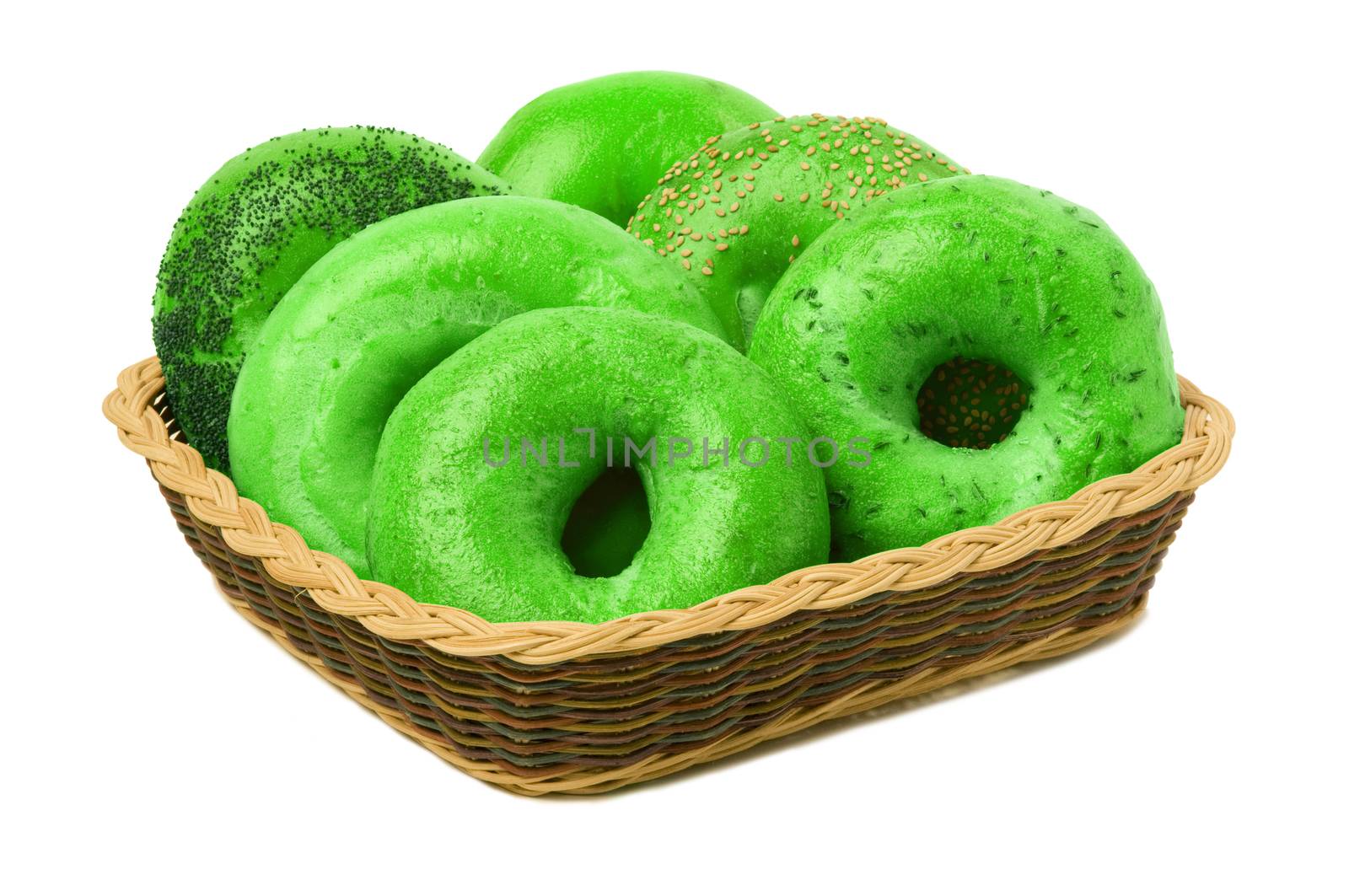 A variety of six green bagels in a basket, isolated against a white background