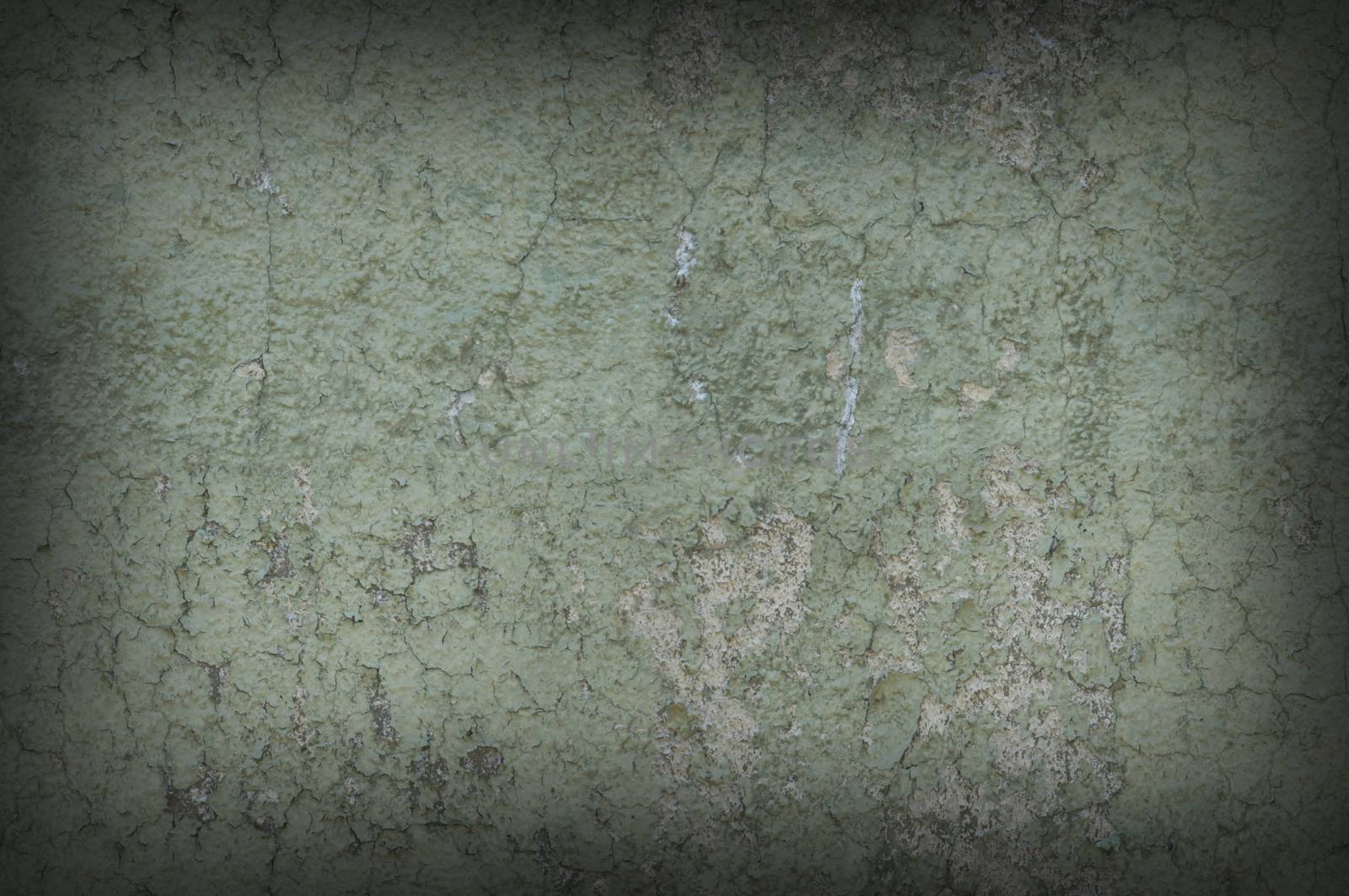 Grayish green weathered and distressed textured wall, dark around the edges