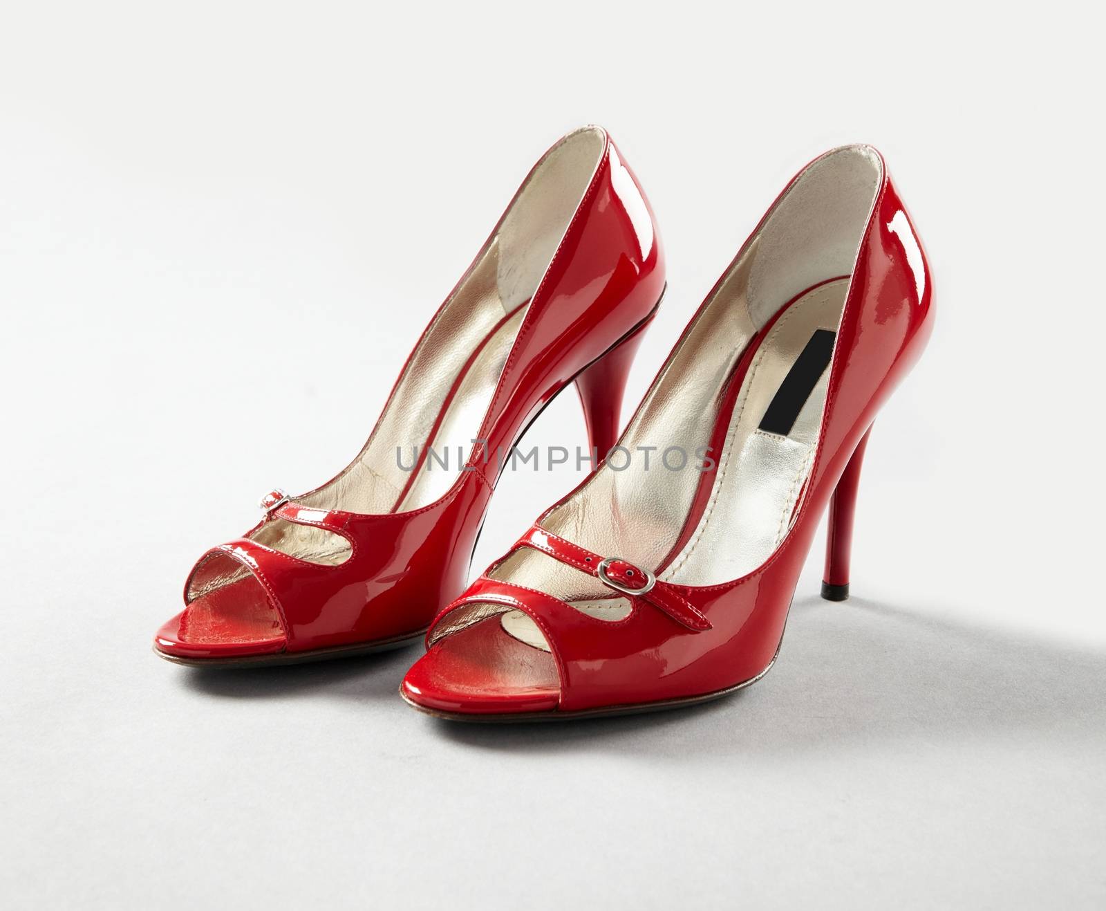 Pair of Glossy High Heels Shoes on white background