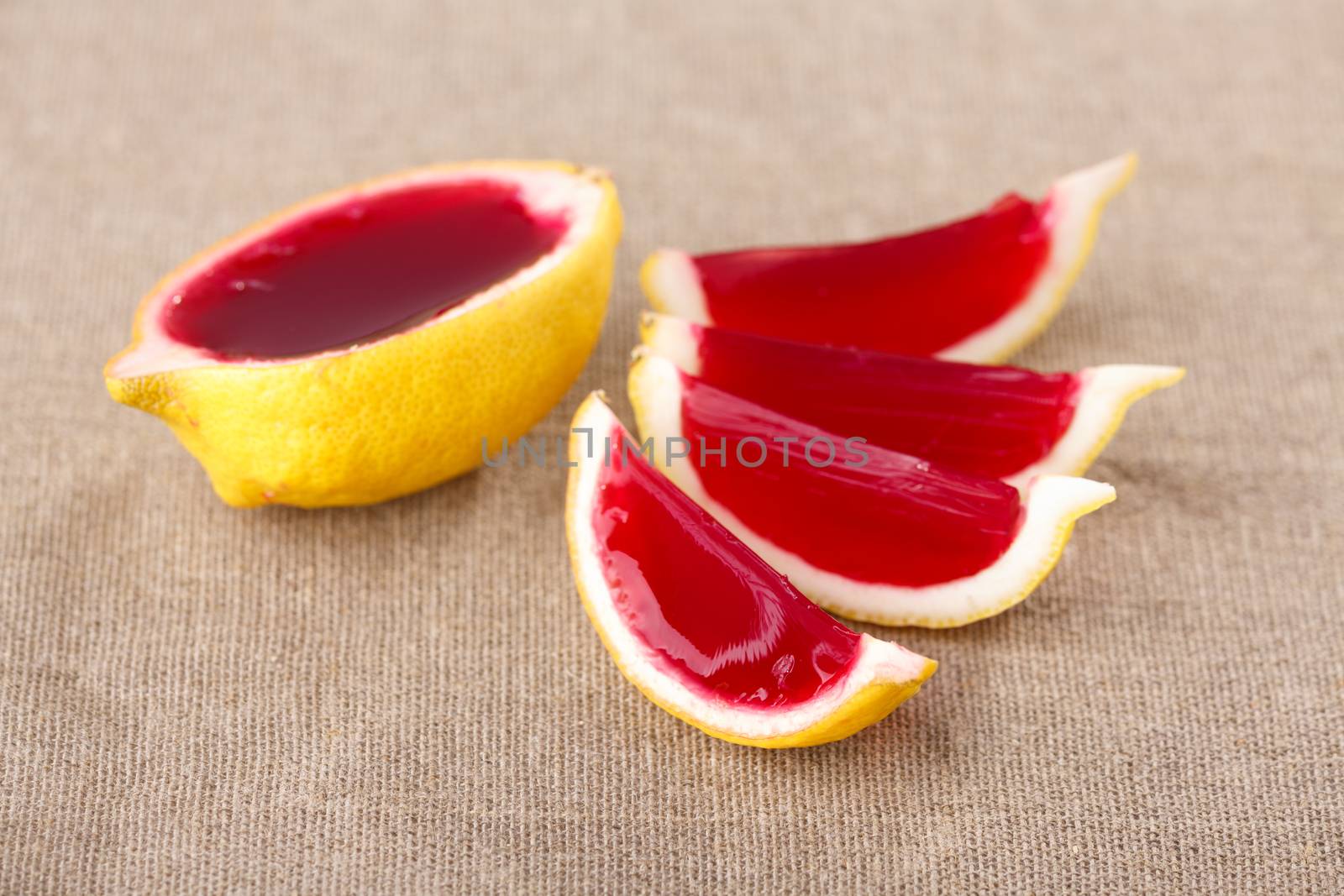 Lemon tequila strawberry jelly (jello) shots on a linen clothed table. Unusual adult party drinks