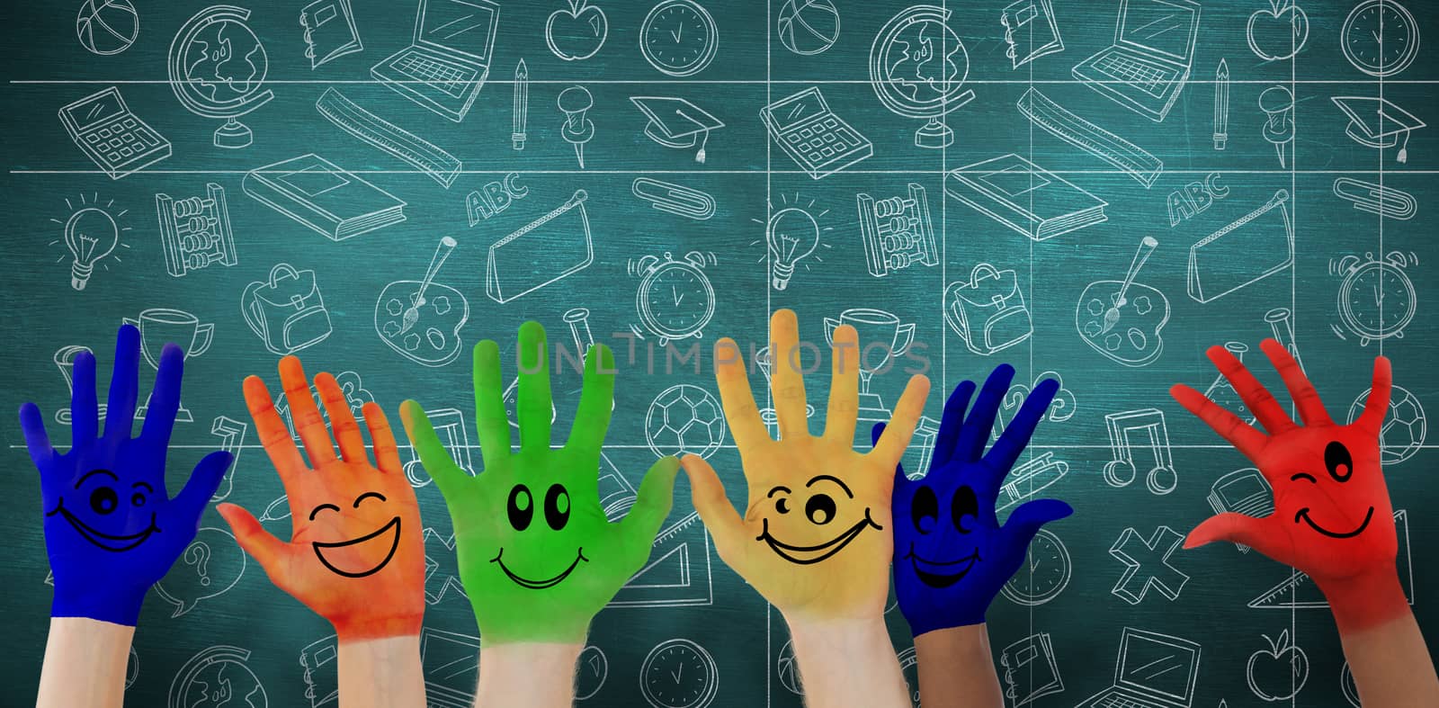Hands with colourful smiley faces against green chalkboard
