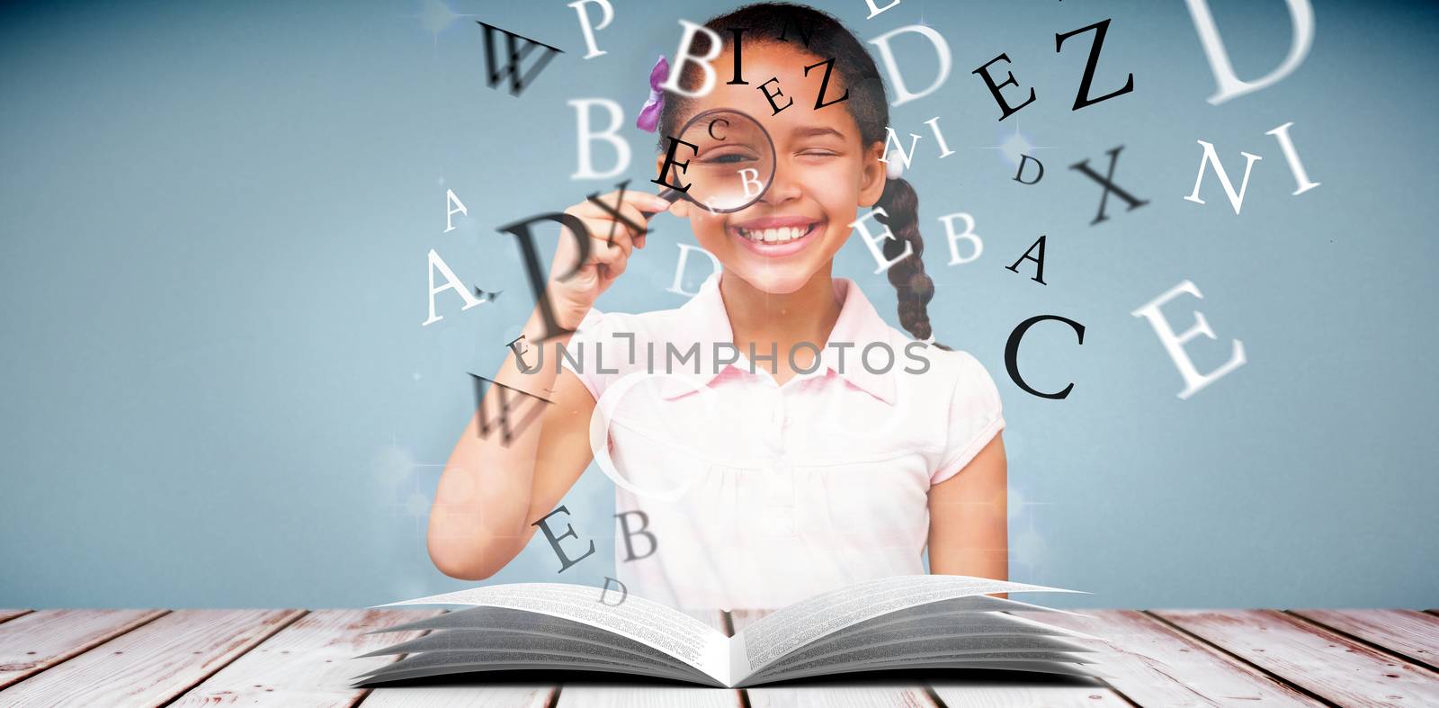 Little girl with magnifying glass against light design shimmering on silver