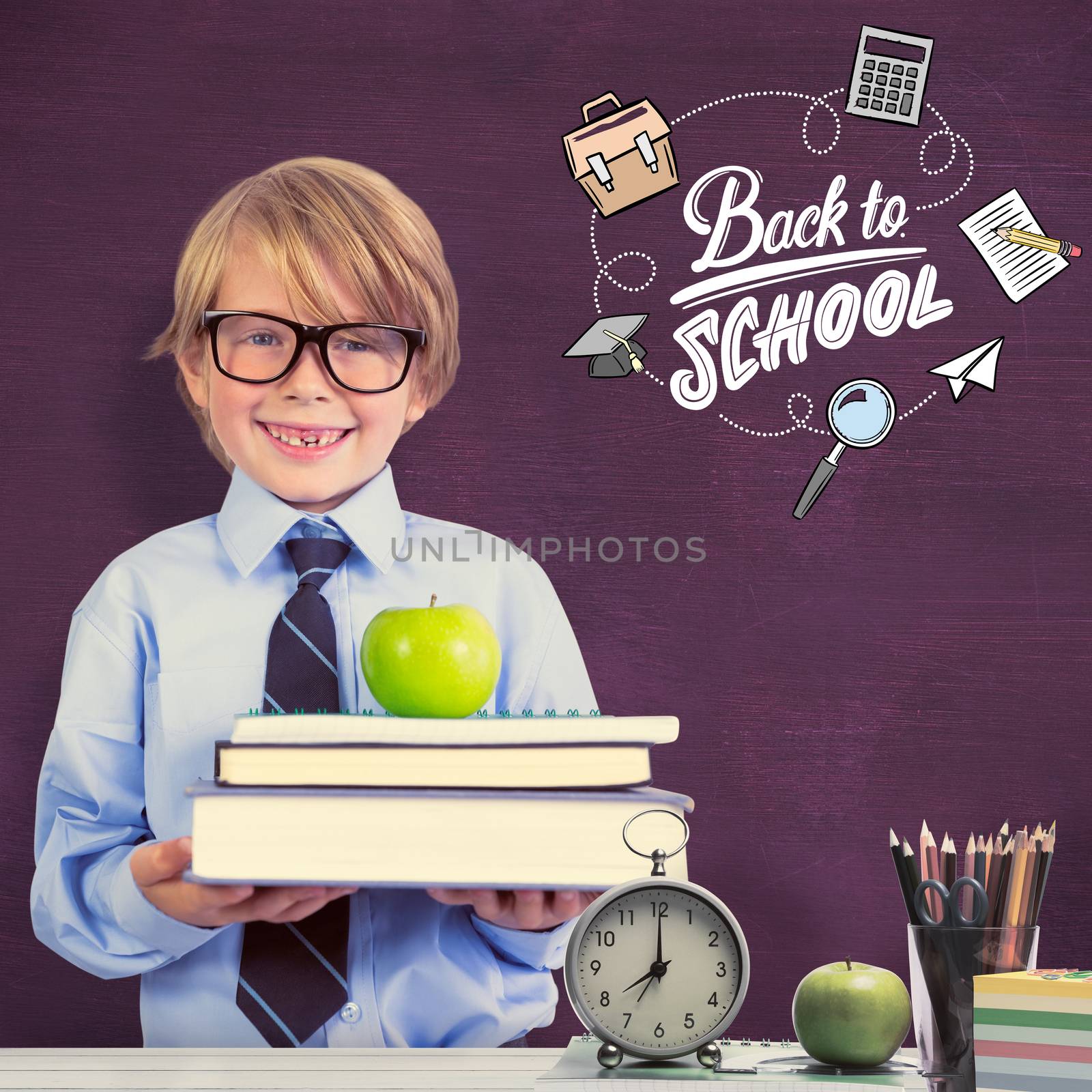Cute pupil holding books and apple against green chalkboard