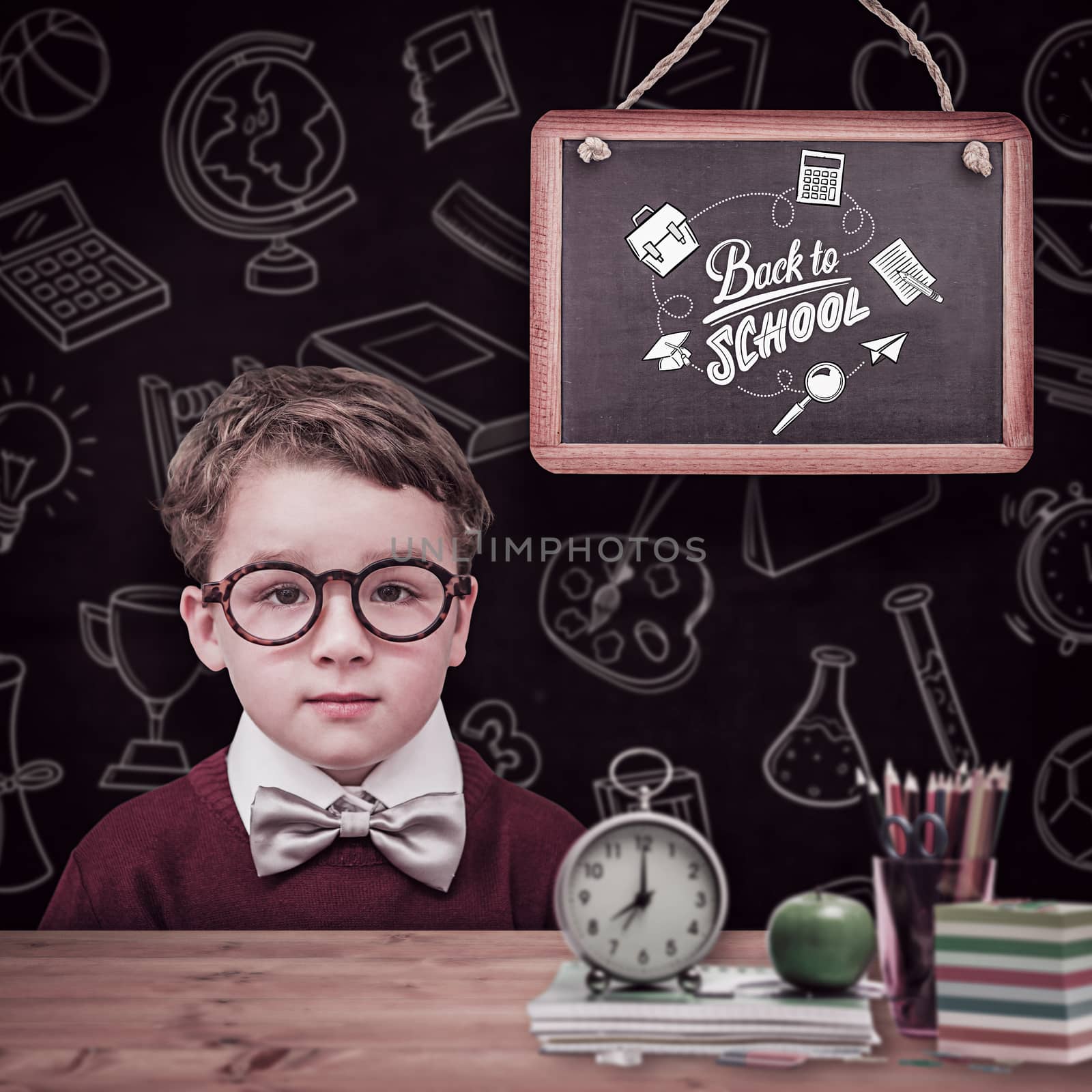 Composite image of cute schoolboy wearing reading glasses by Wavebreakmedia