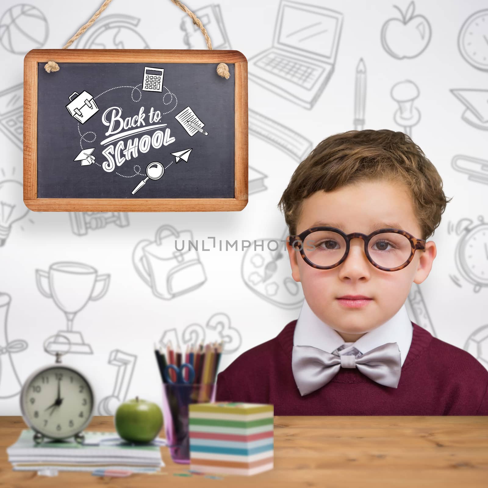Cute schoolboy wearing reading glasses against bleached wooden planks background