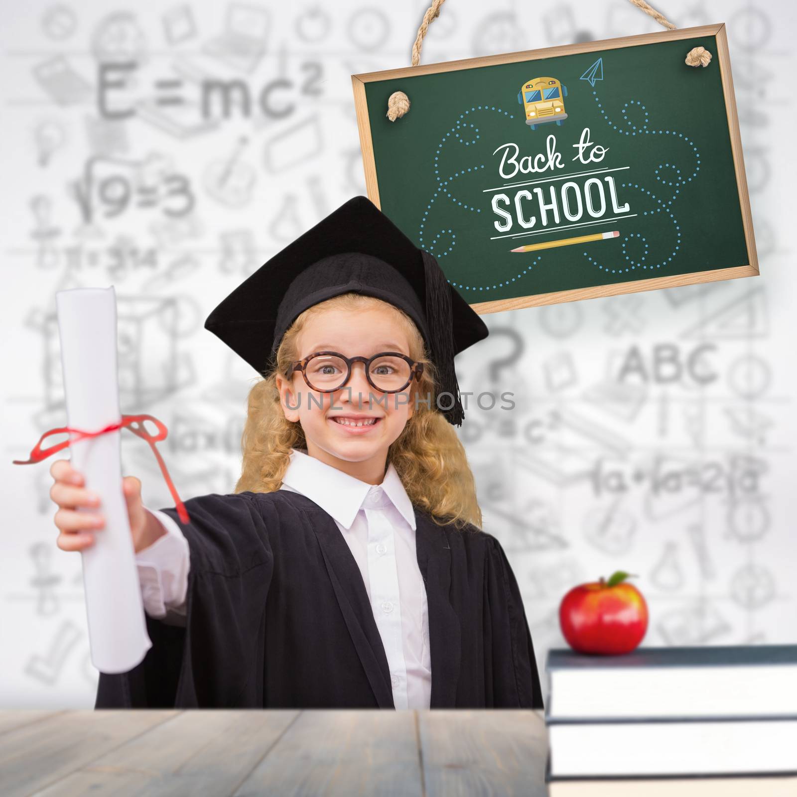 Schoolgirl with graduation robe and holding her diploma against pale grey wooden planks