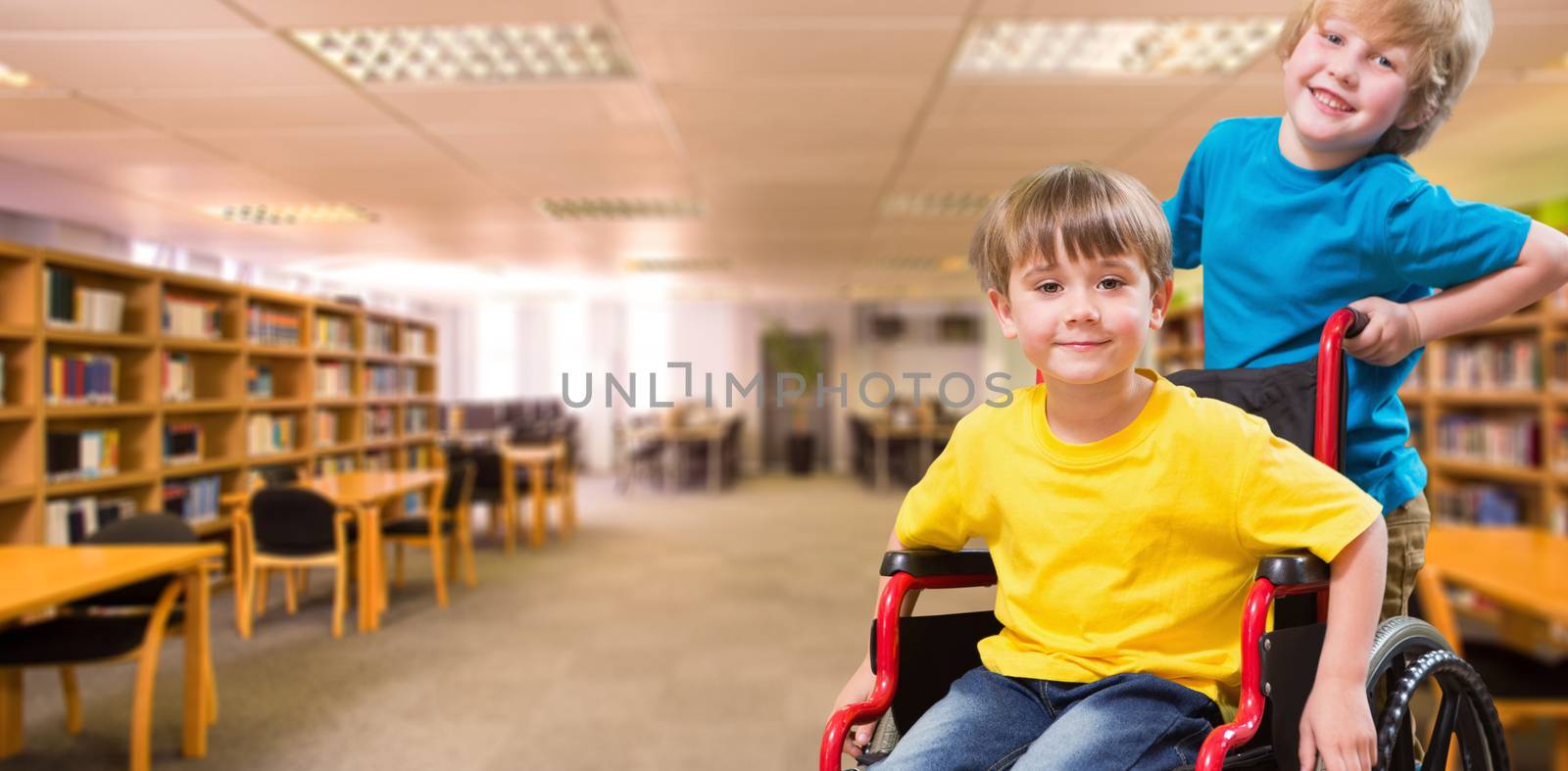 Happy boy pushing friend on wheelchair against view of library