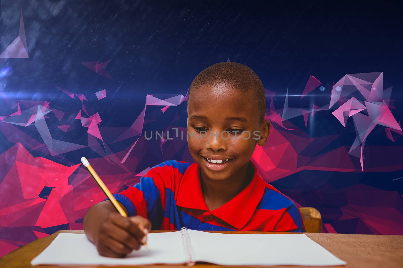 Pupil working at desk against dark abstract design