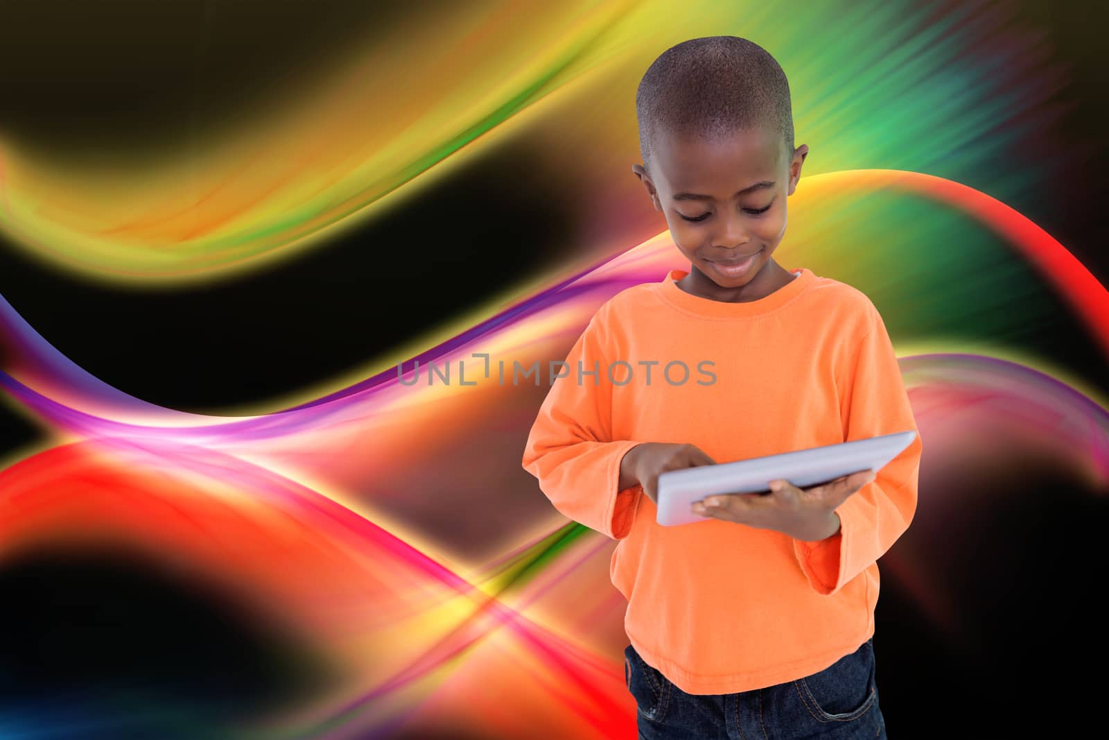 Composite image of cute boy using his tablet pc by Wavebreakmedia