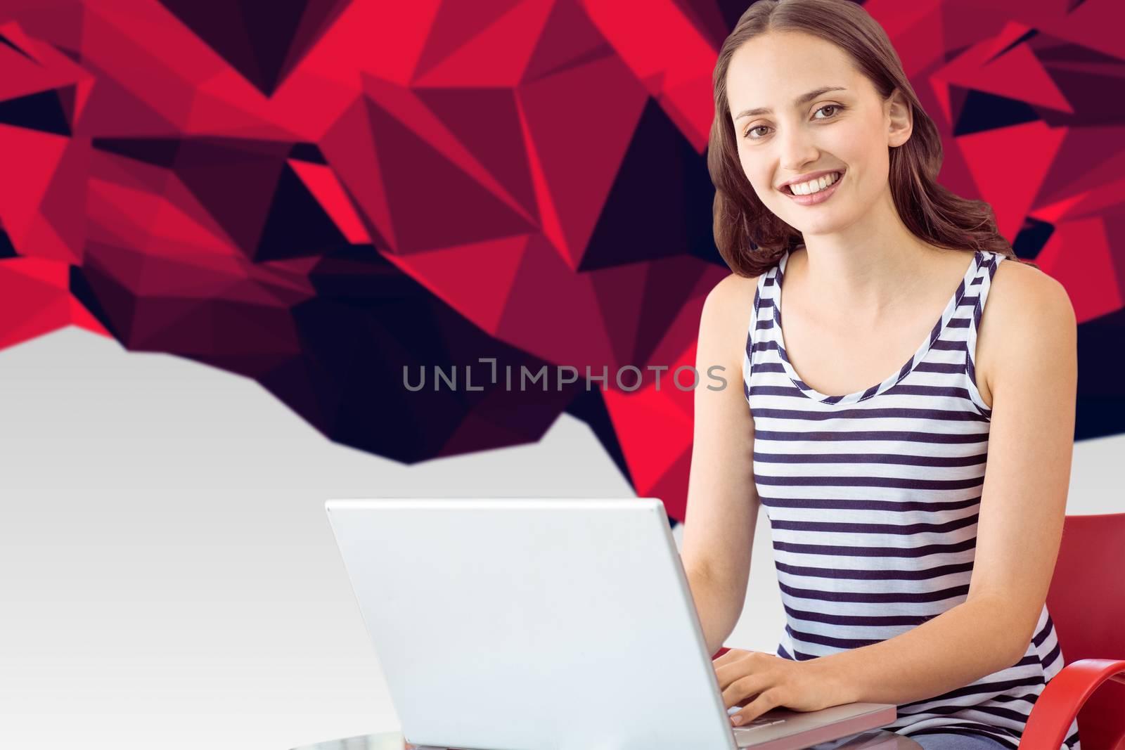 Student on laptop against red abstract design