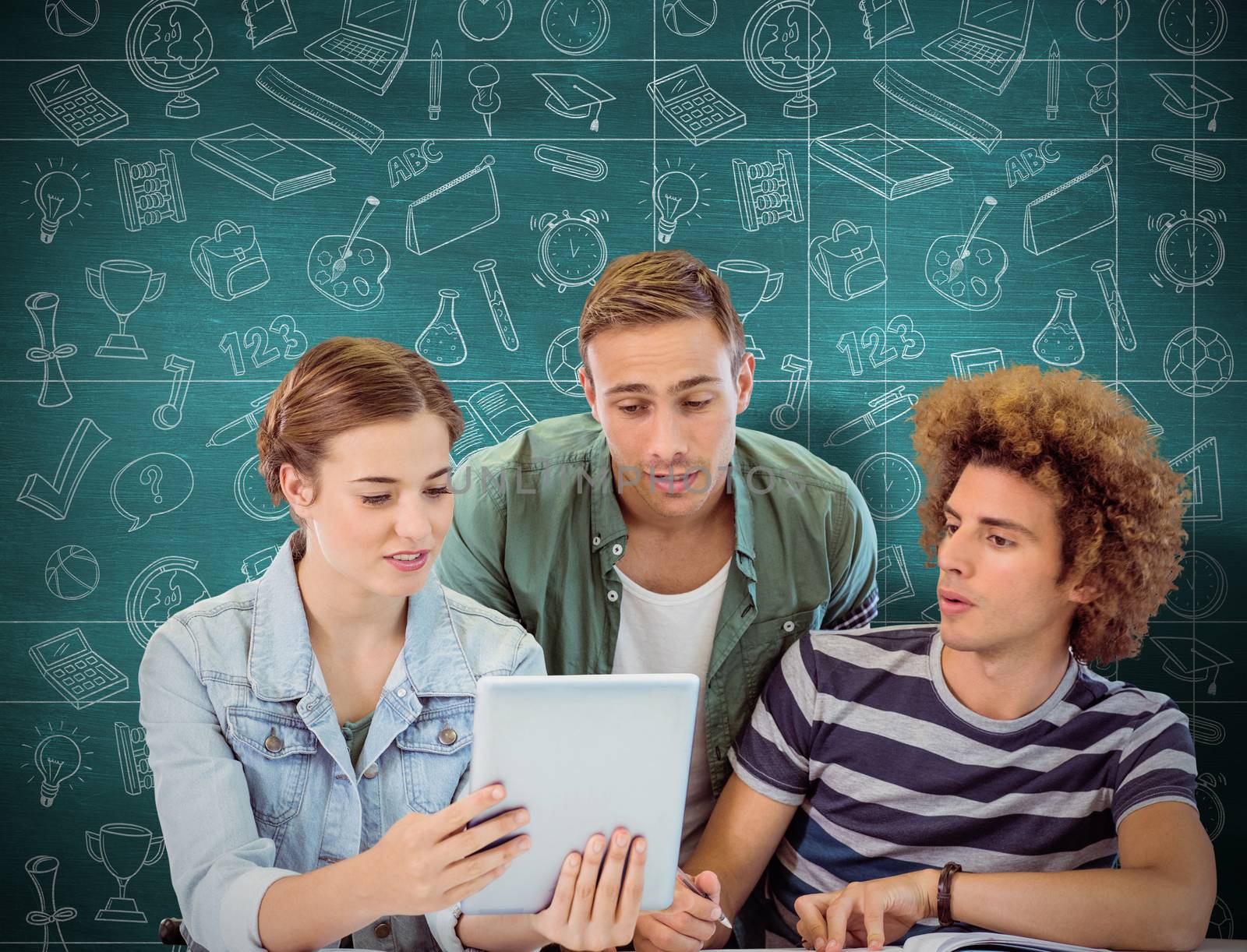 Fashion students using tablet  against green chalkboard