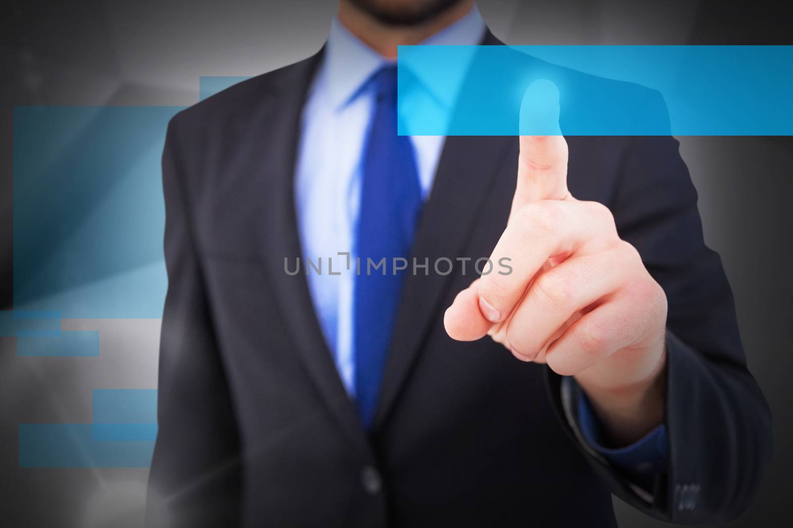 Businessman pointing his finger at camera against abstract grey room