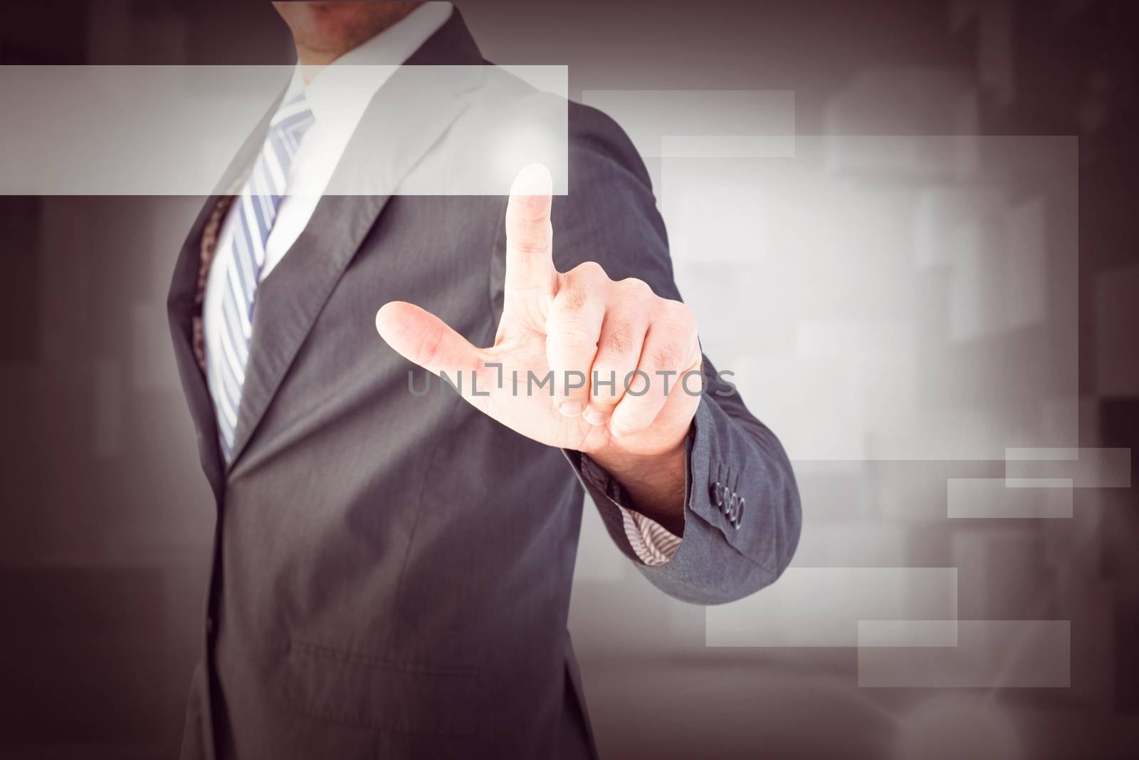 Businessman pointing with his finger against abstract white room