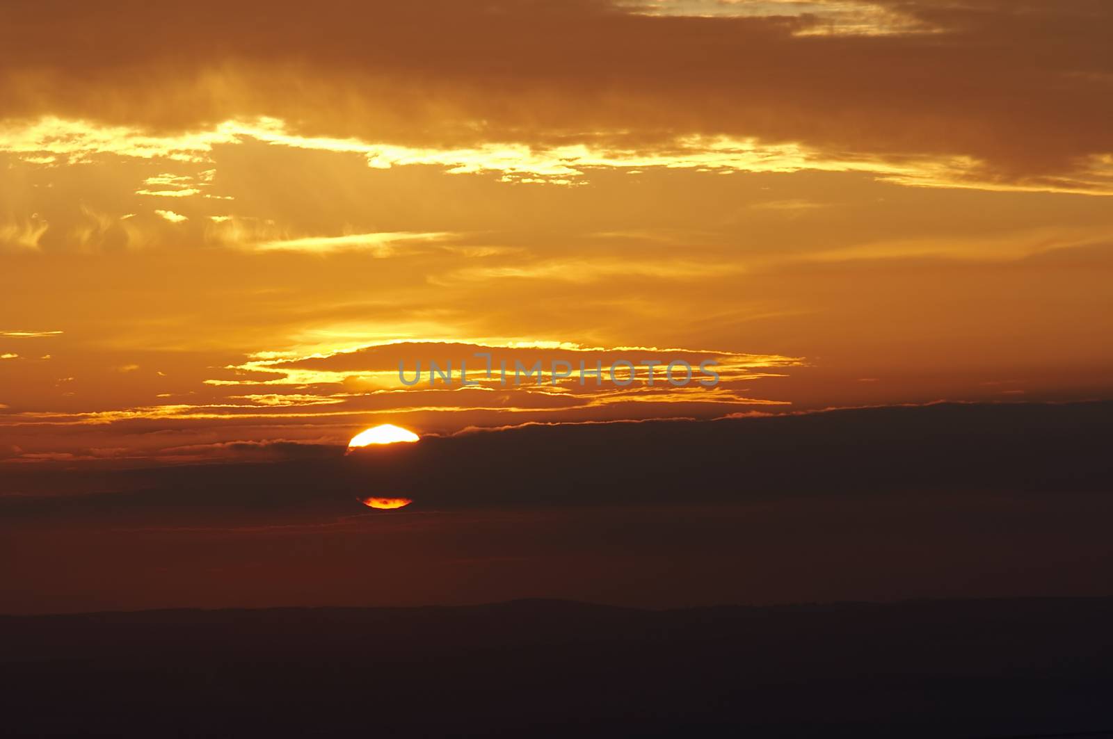 Setting Sun Behind A Cloud by Mibuch