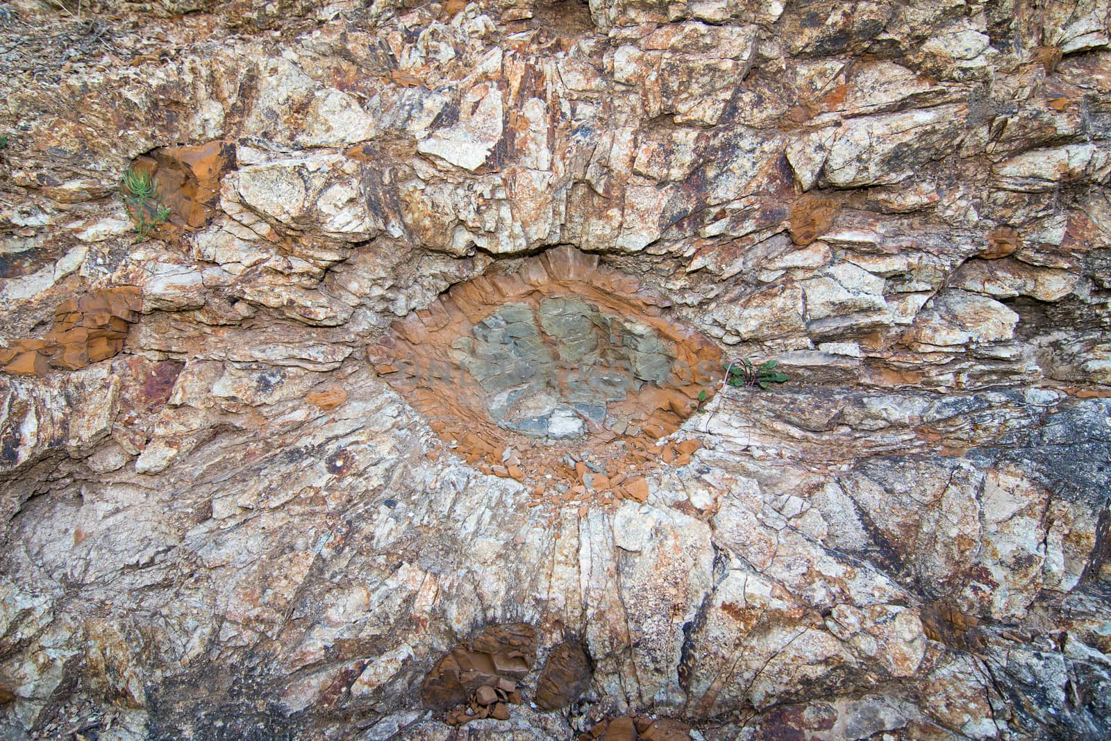 National Natural Landmark - Stone Suns -  is a unique geological formation, which is located in the PLA Czech Central Mountains about 1 km southeast of the village Hnojnice. This natural phenomenon originated during ancient volcanic eruptions. It is former quarry, whose walls are formed from orange stone. It is marlite which creates interesting formations in the form of stone suns. The site is a unique example of volcanic activity in the Tertiary. In 1992 the area was declared a national natural monument. Hnojnice village, Czech republic.