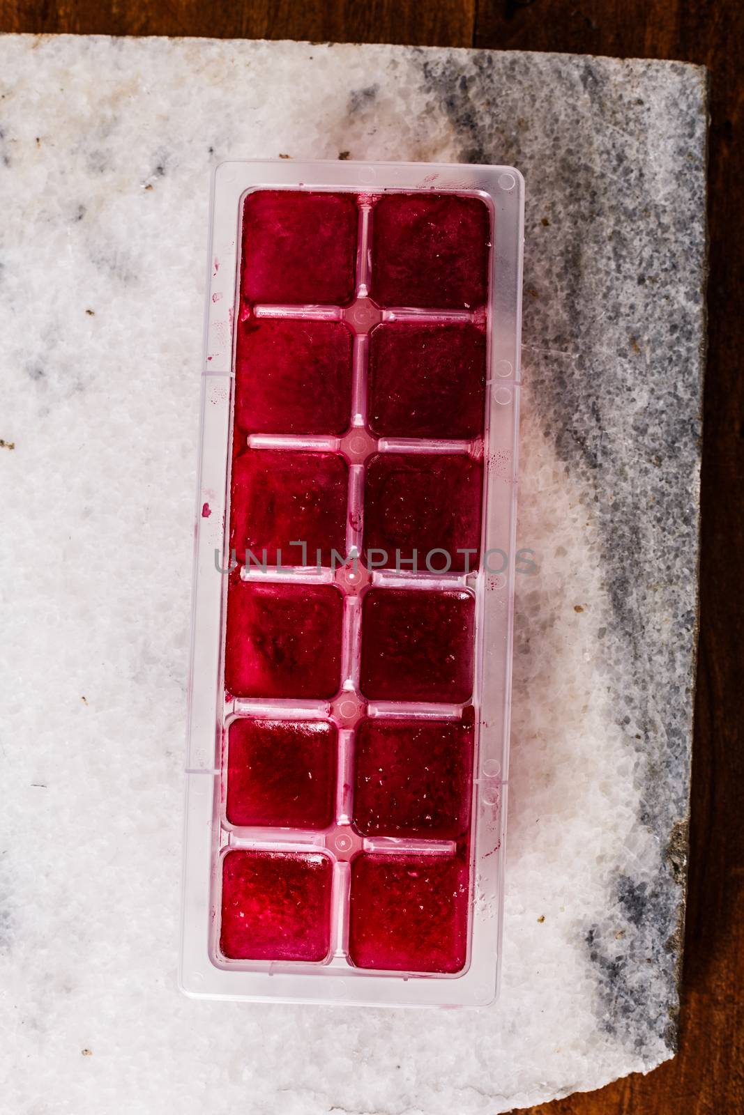 Frozen hibiscus tea also known as karkade, agua fresca or red sorrel on a marble plate