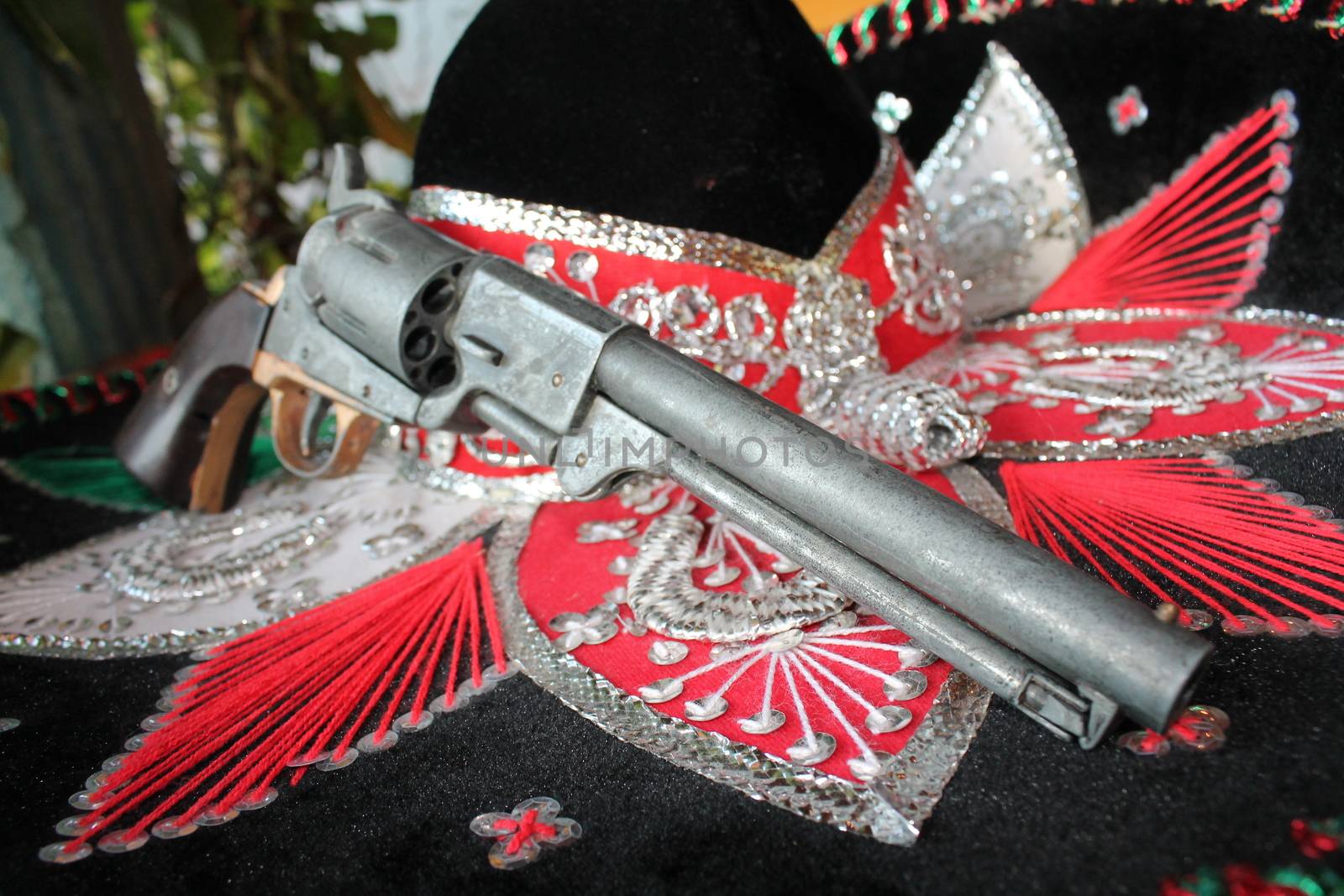 sequin and decorative ornate mexican hat ready for a fiesta with a gun