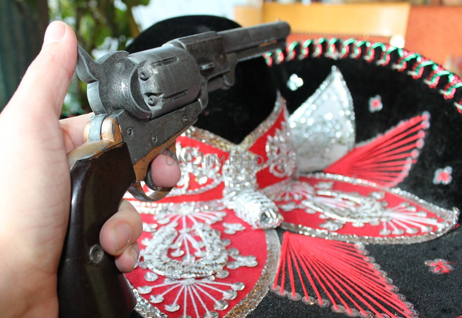 sequin and decorative ornate mexican hat ready for a fiesta with a gun by cheekylorns