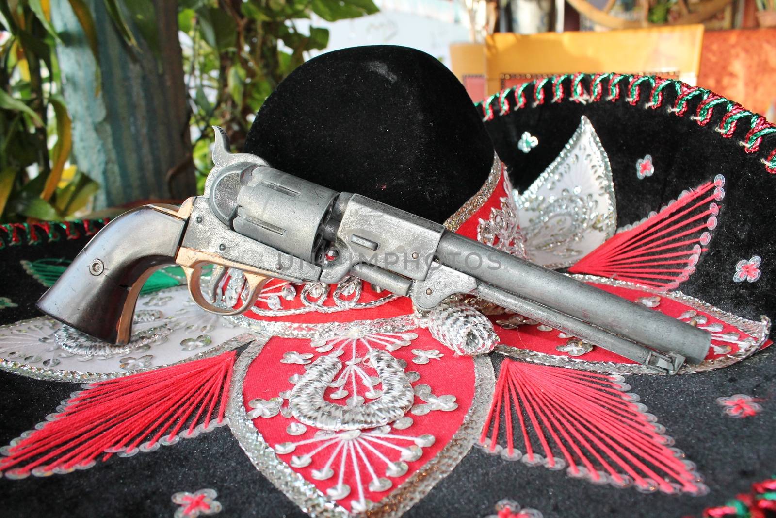 sequin and decorative ornate mexican hat ready for a fiesta with a gun by cheekylorns