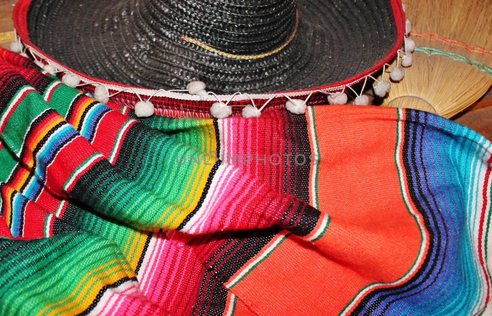 fiesta mexican poncho rug in bright colors with sombrero background with copy space by cheekylorns