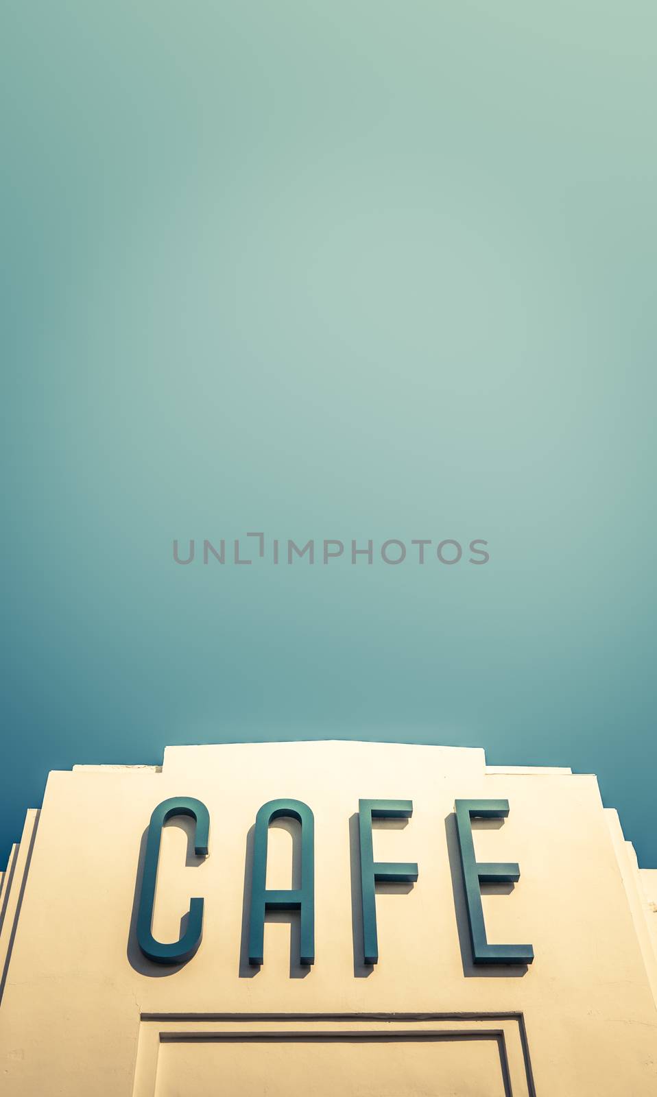 A Retro Art Deco Sign For A Cafe Or Restaurant Against A Blur Sky With Copy Space