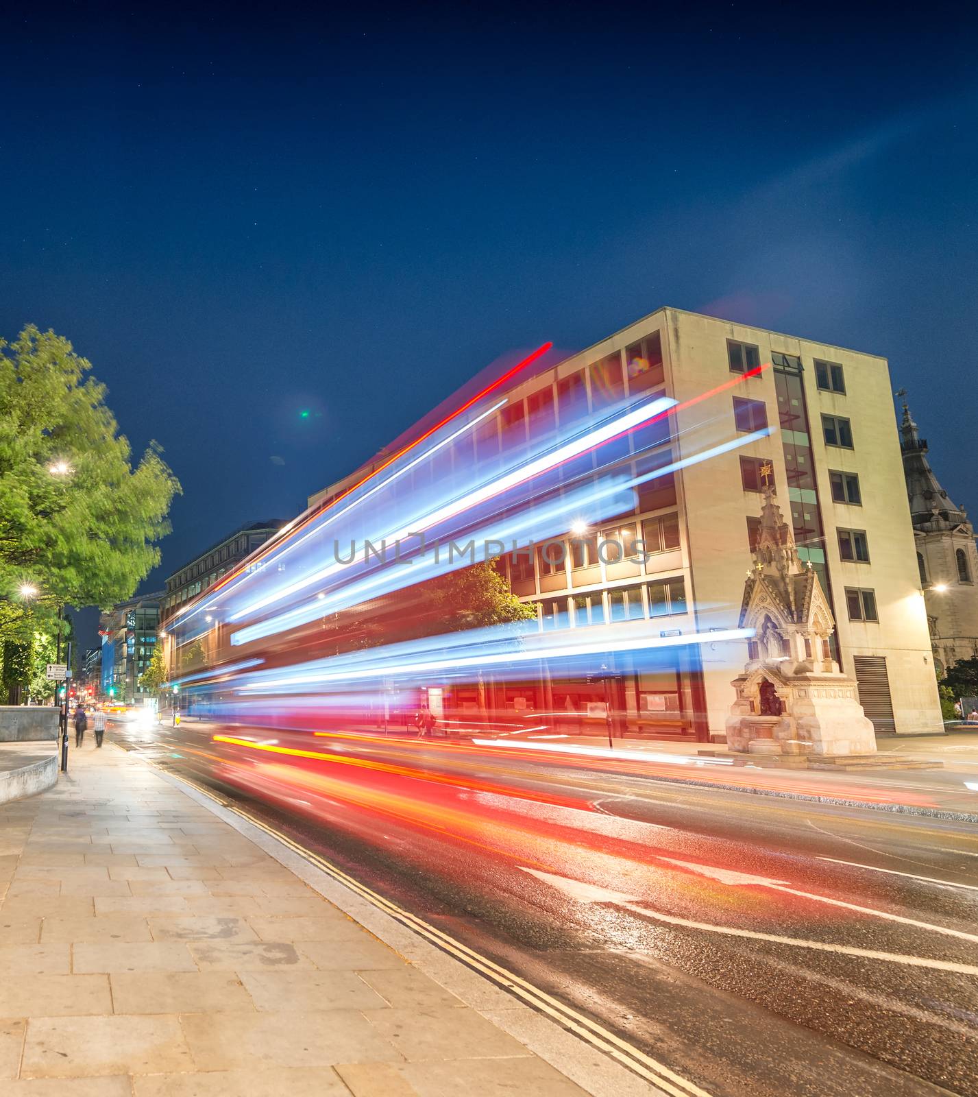 Double Decker bus light trails in London streets by jovannig