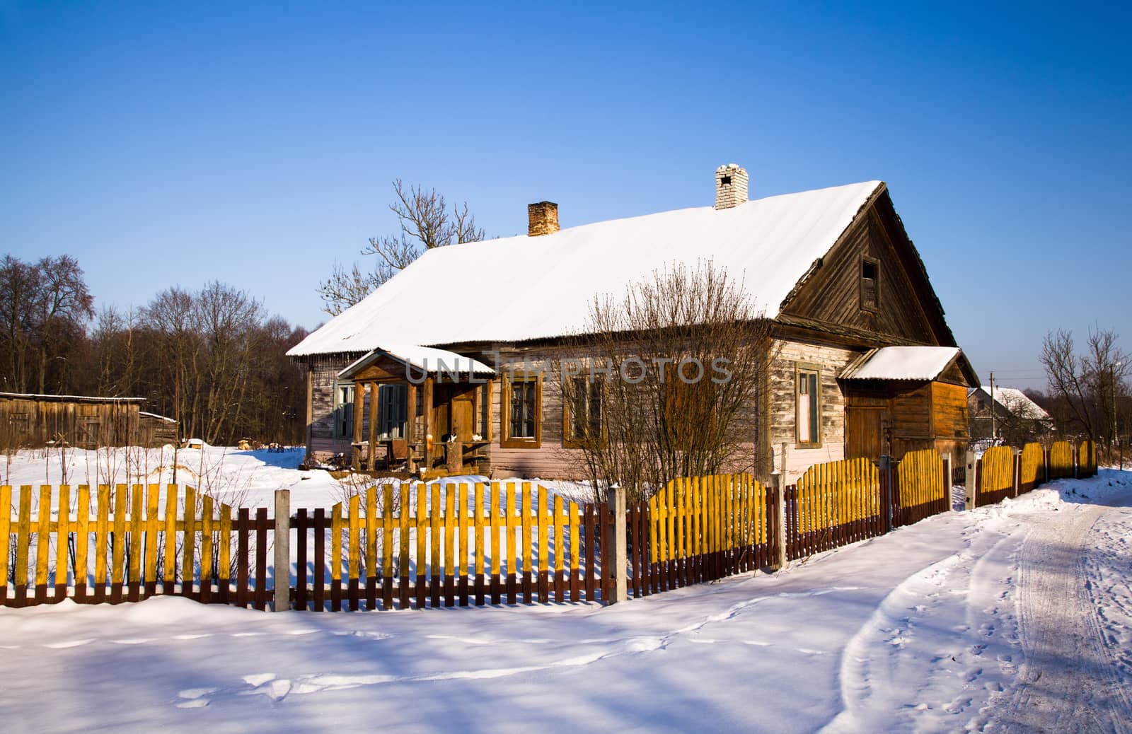 a wooden building covered with snow in the winter time