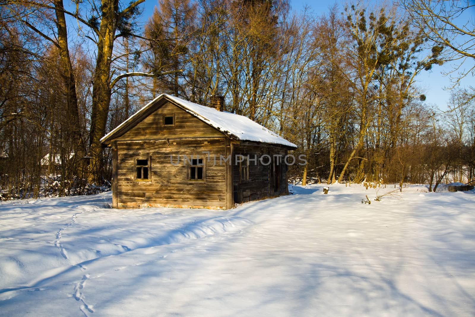 a wooden building covered with snow in the winter time