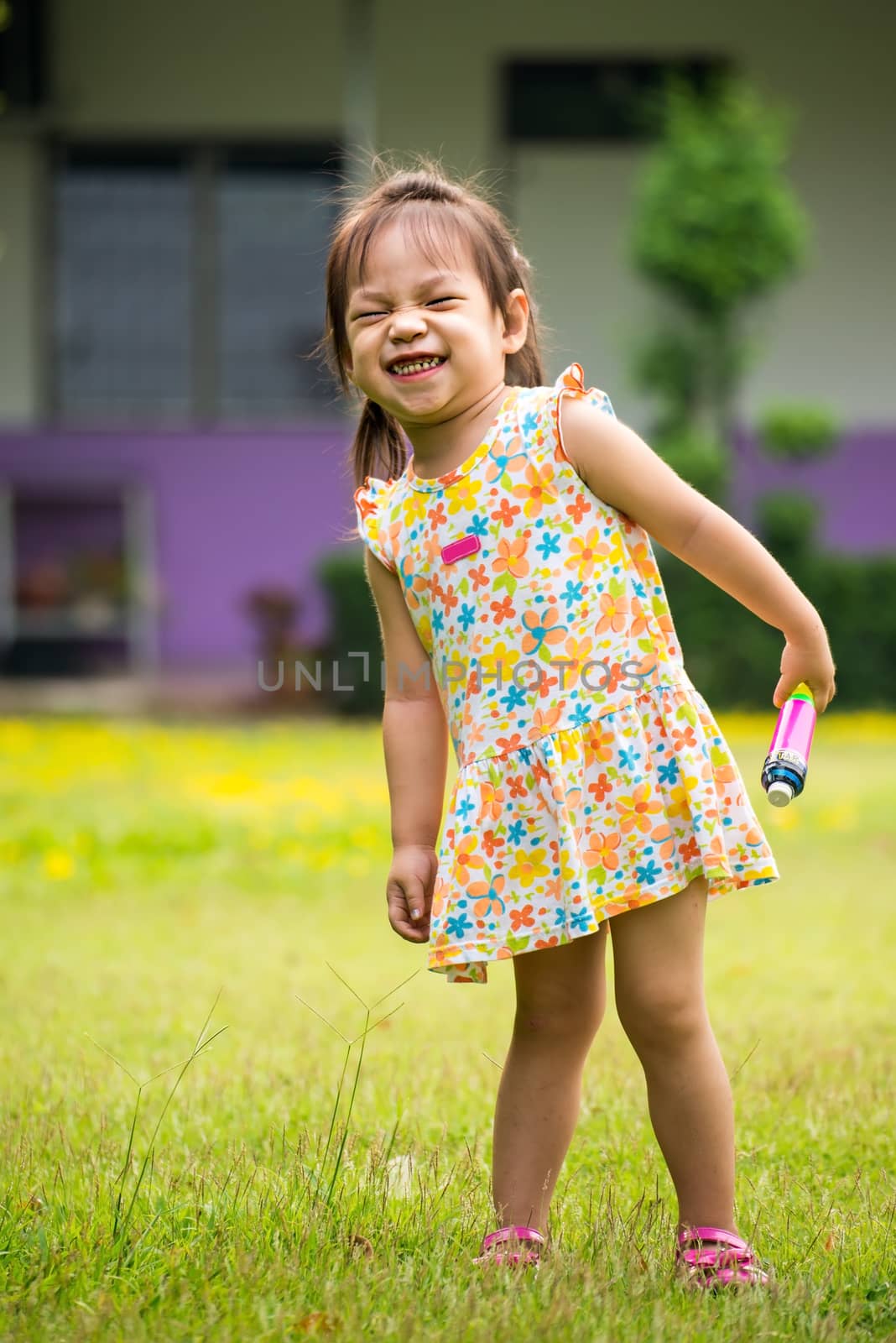 Outdoor portrait of sad little girl playing in summer park by Yuri2012