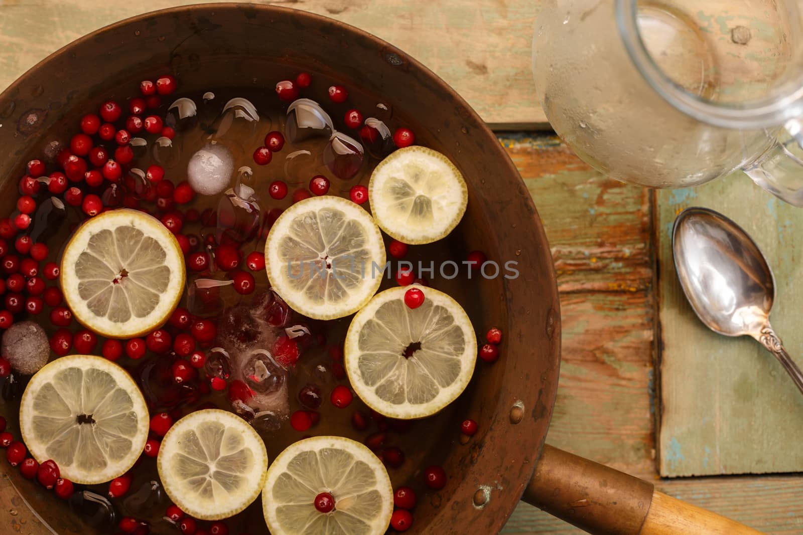 Cranberry lemon punch in a brass bowl on wooden table