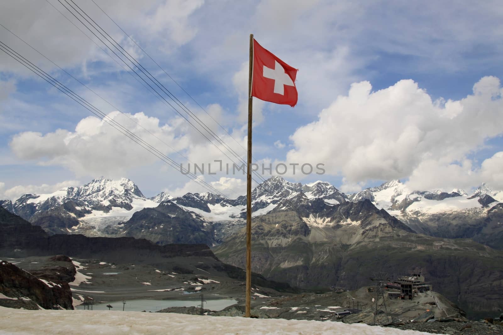 Swiss alps near  mont Matterhorn and Swiss flag 