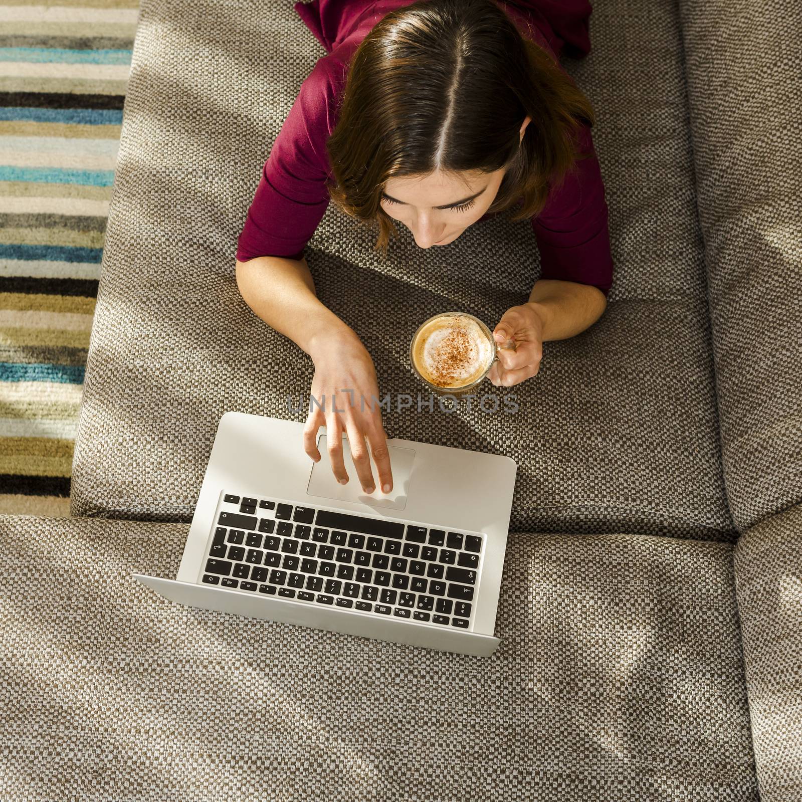 Beautiful woman at home working while drinking one capuchino