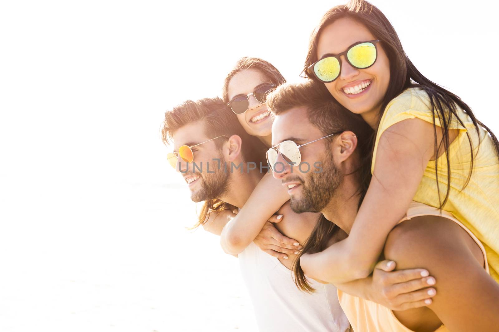 Group of friends having fun at the beach