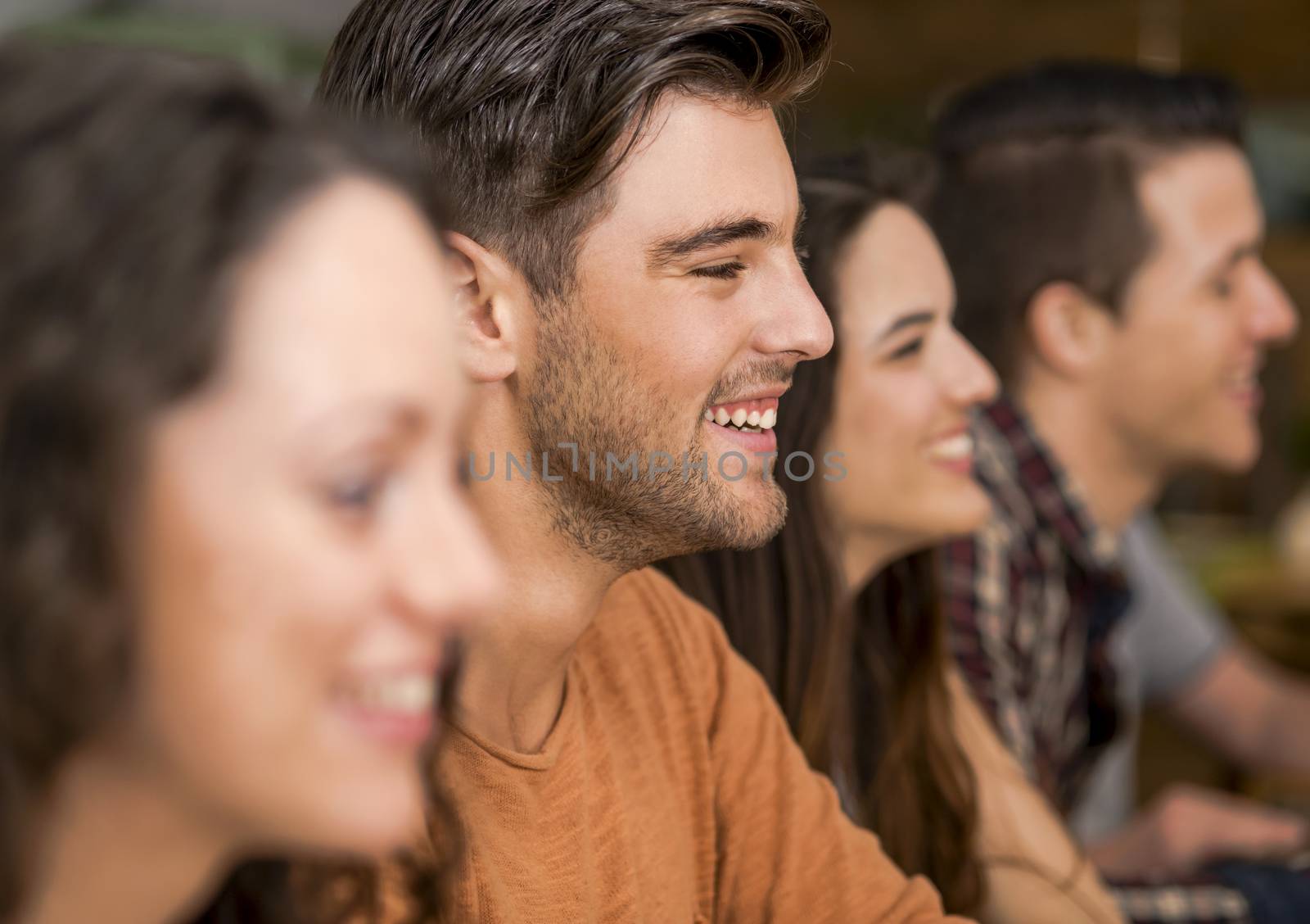 Multi-Ethnic Group of happy friends having fun at the restaurant