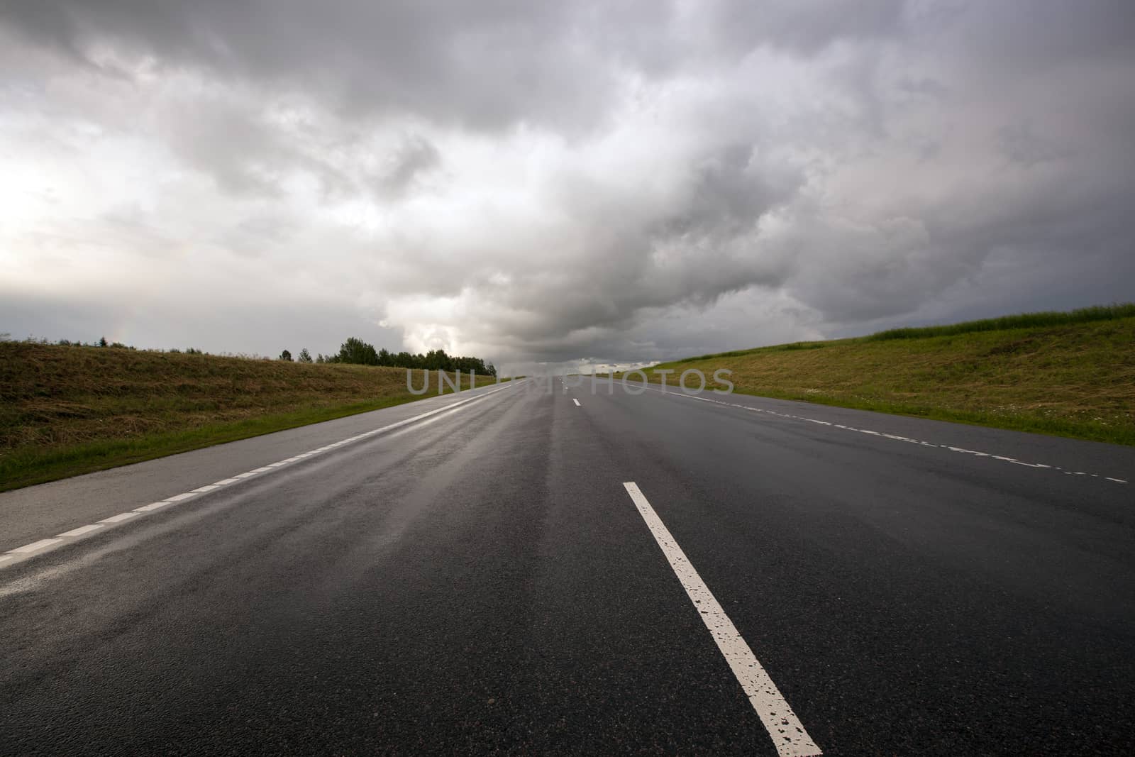   the asphalted road to time of storm weather. Belarus