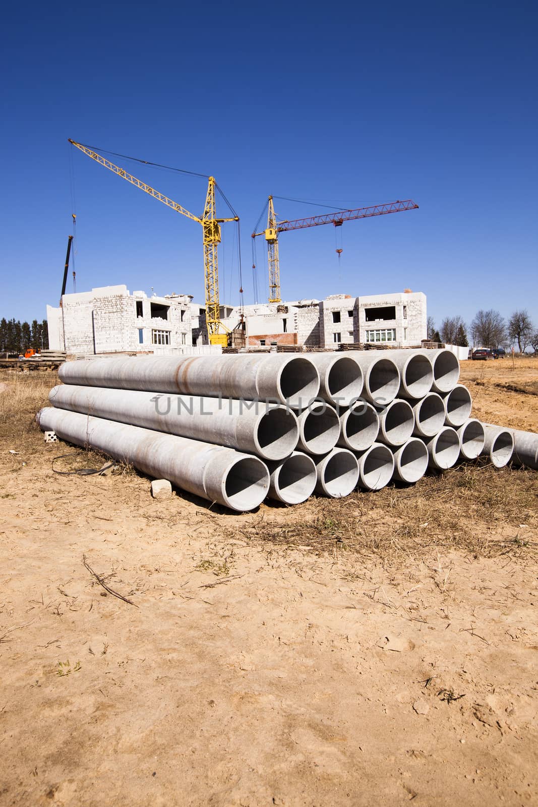   the construction materials lying near the building under construction