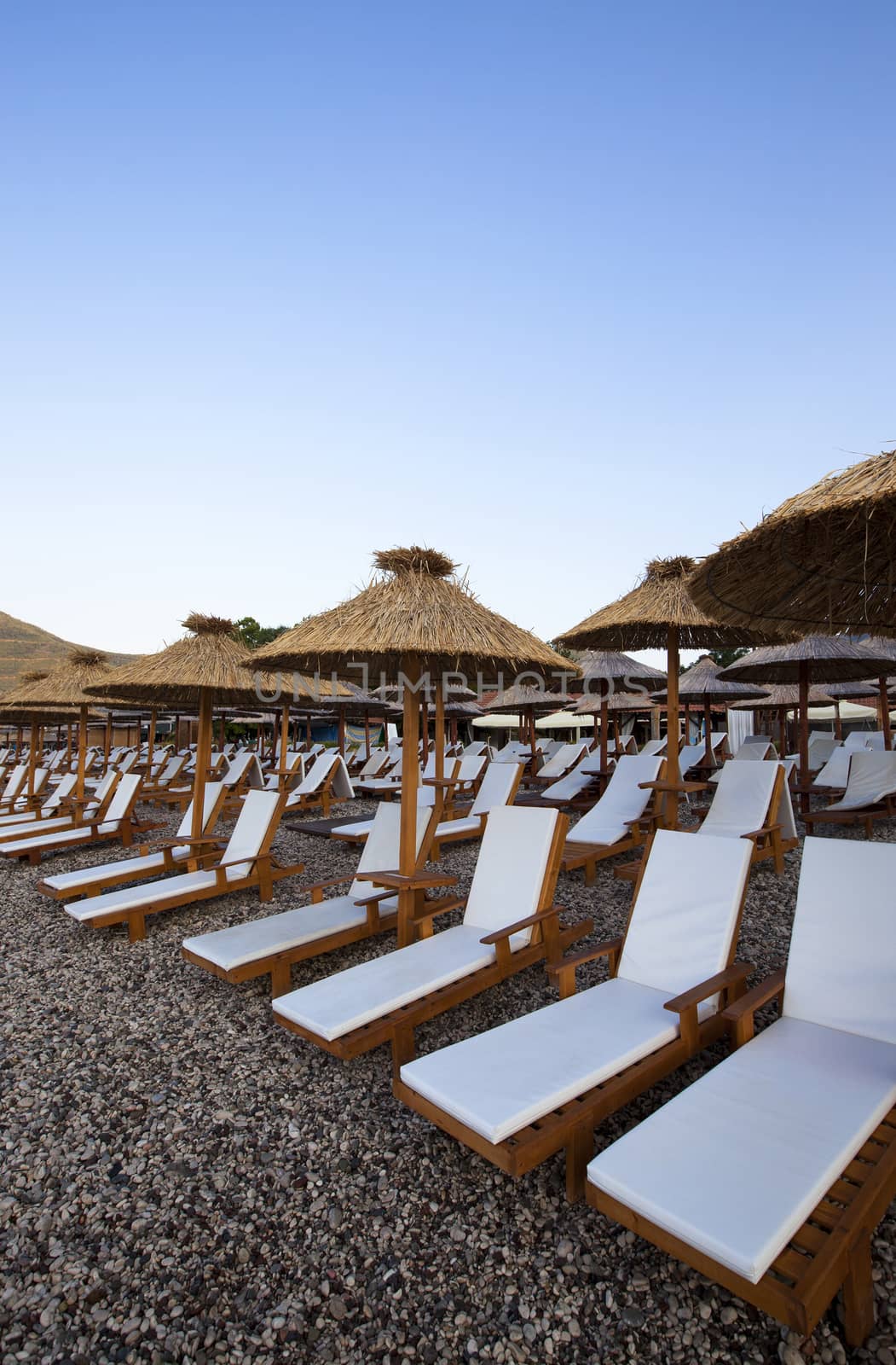   the plank beds being on a pebble beach in the city of Budva, Montenegro