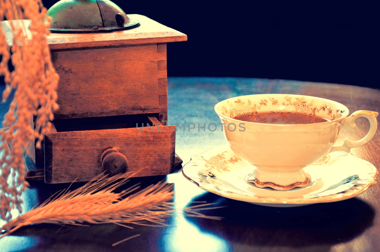 Food and drinks conceptual image. Antique porcelain cup of decaffeinated coffee on the table. Dark retro vintage picture.