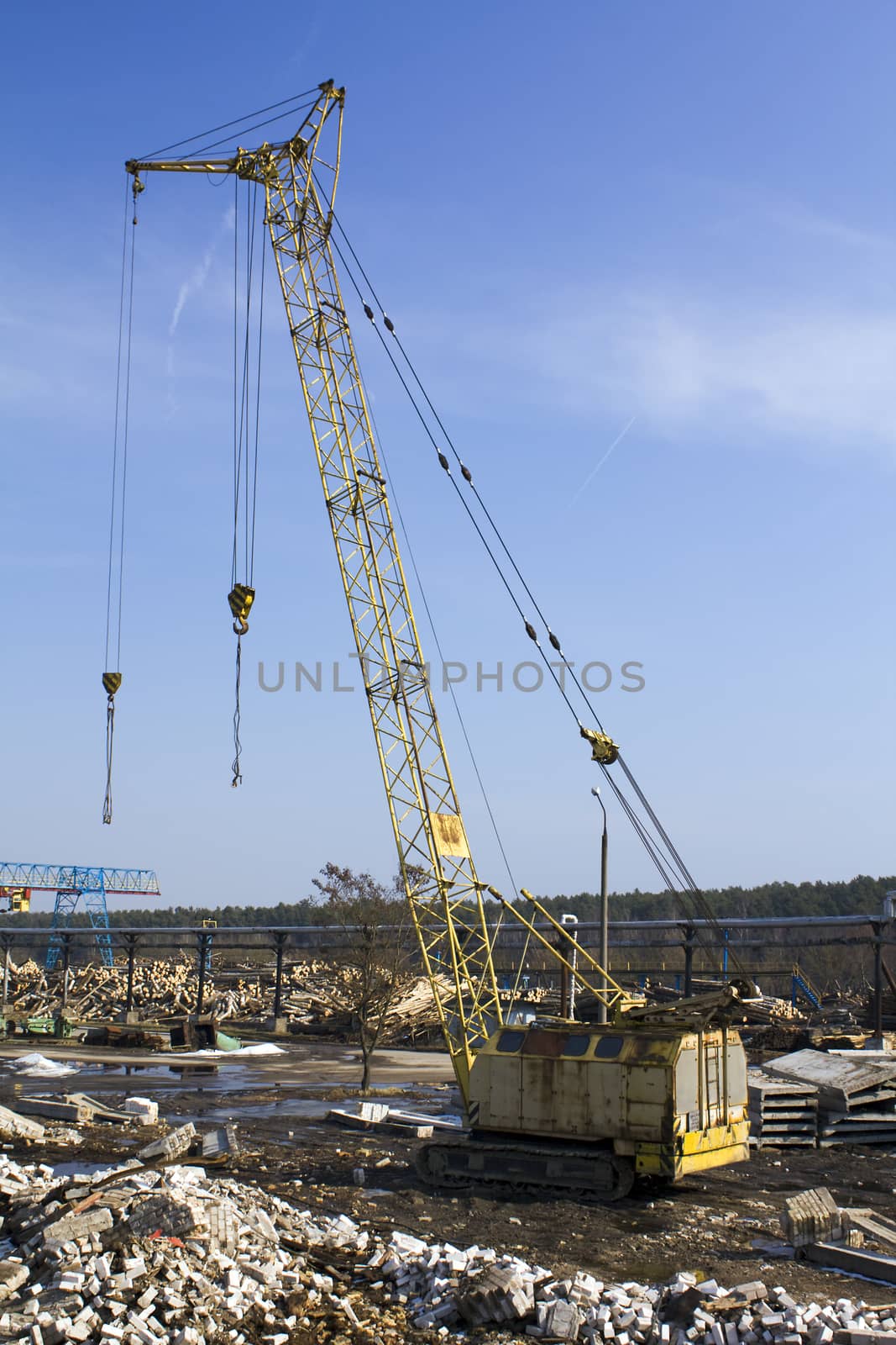 a crane on the territory of the woodworking factory.