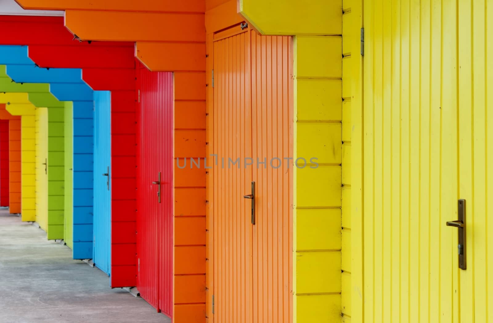 colourful paint wooden Victorian beach hut at the seaside by cheekylorns