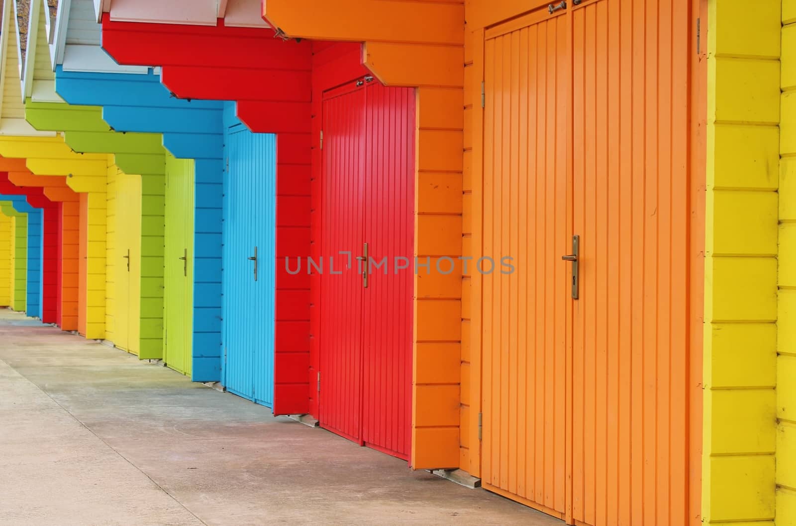 colourful paint wooden Victorian beach hut at the seaside by cheekylorns