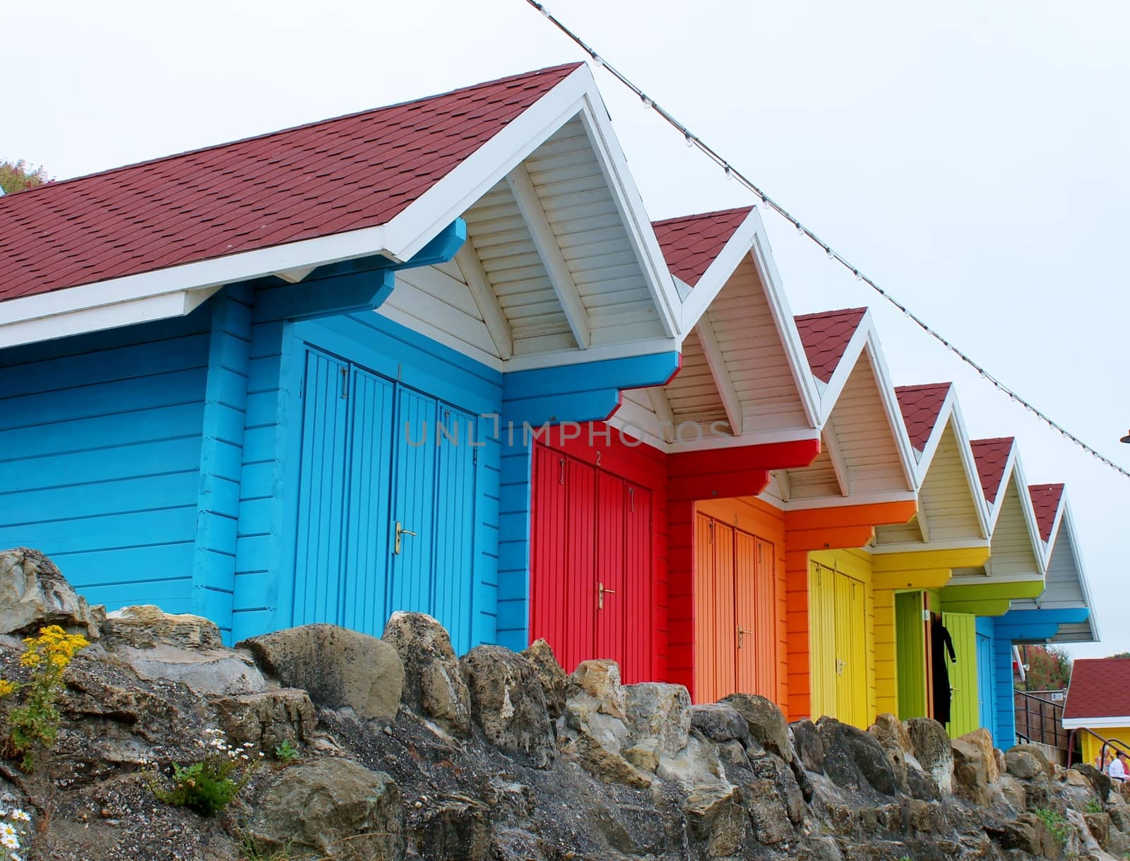 colourful paint wooden Victorian beach hut at the seaside