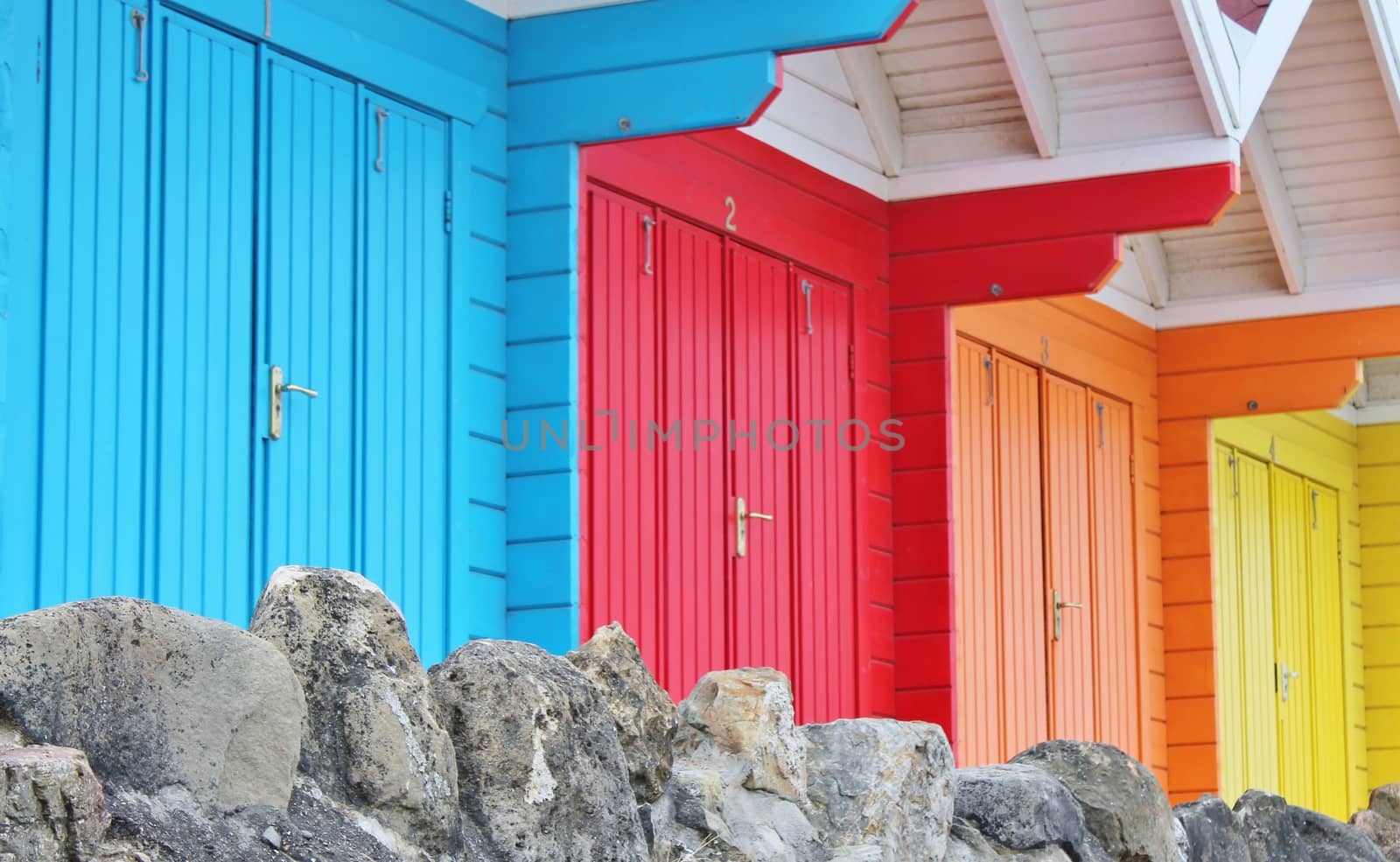 colourful paint wooden Victorian beach hut at the seaside by cheekylorns