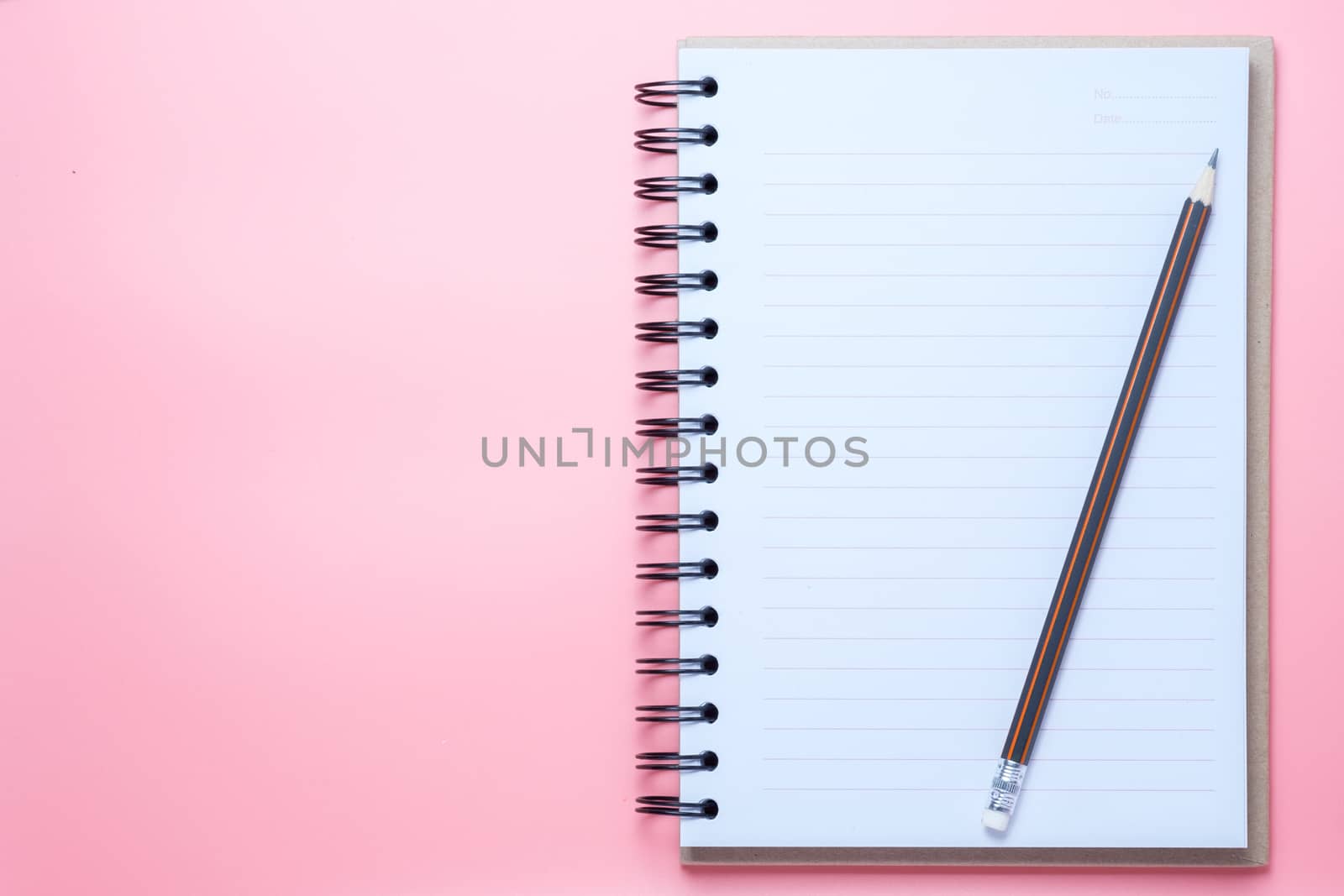 Notebook and pencil on pink background by zneb076