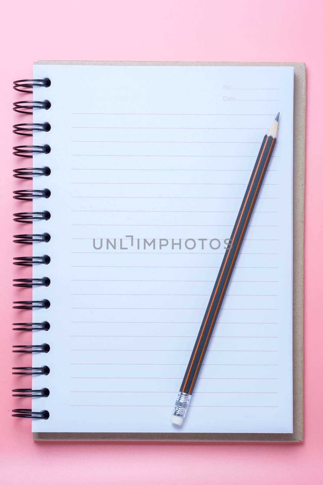 Notebook and pencil on pink background by zneb076