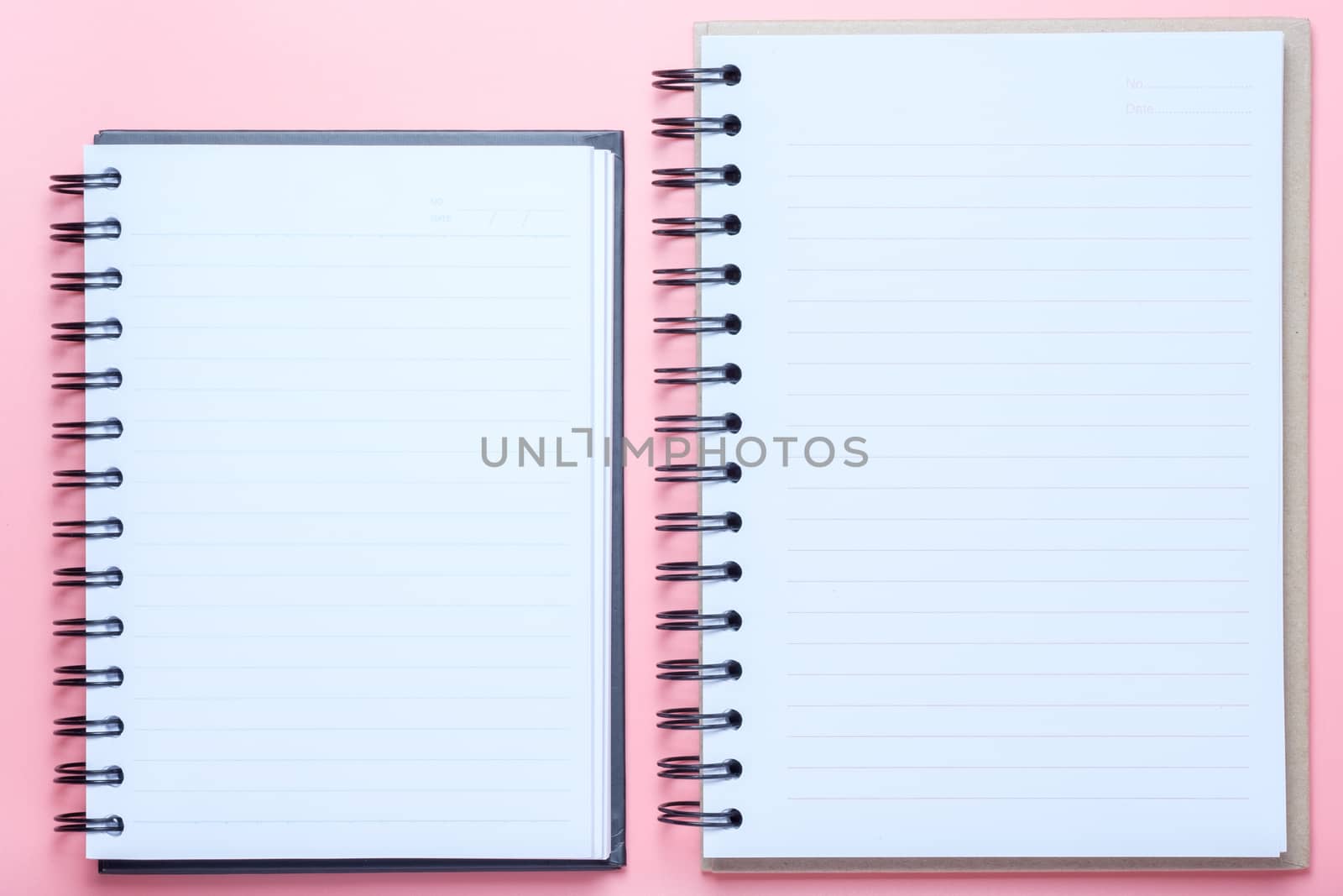 Notebook on pink background.